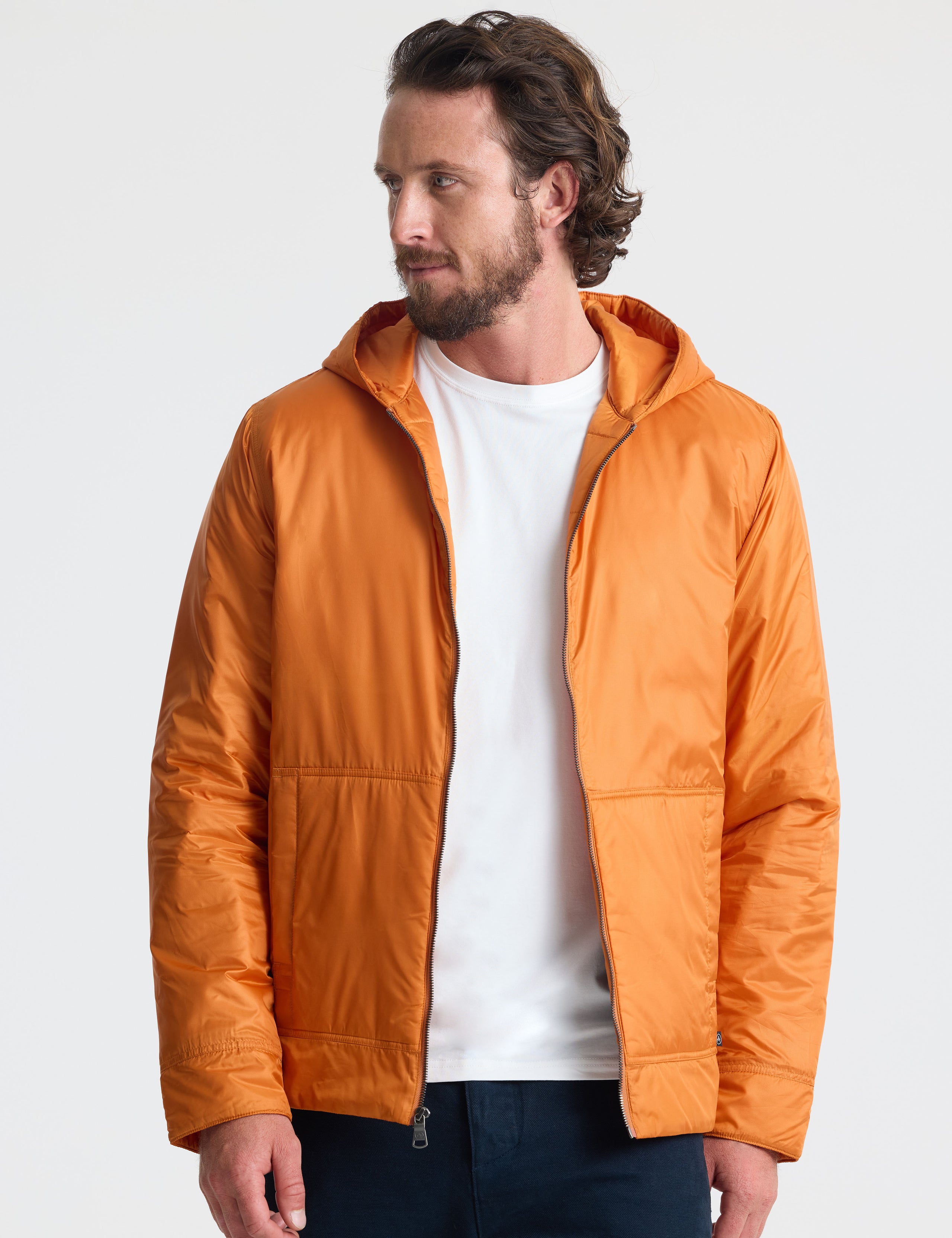 Front view of man wearing unzipped Eco Space Hoodie in Autumn Orange from AETHER Apparel.