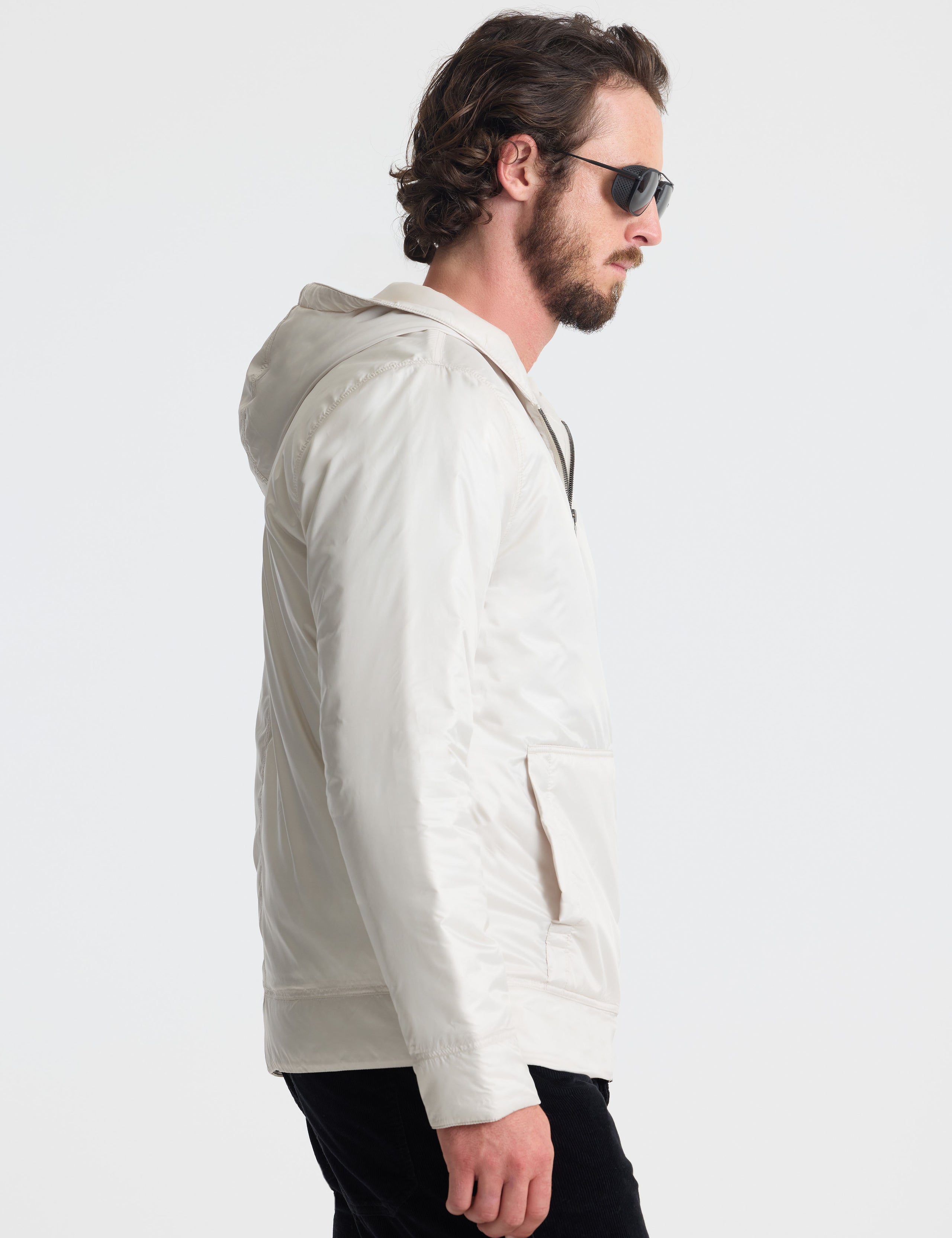 Right profile view of man wearing Eco Space Hoodie in Bone white from AETHER Apparel. 