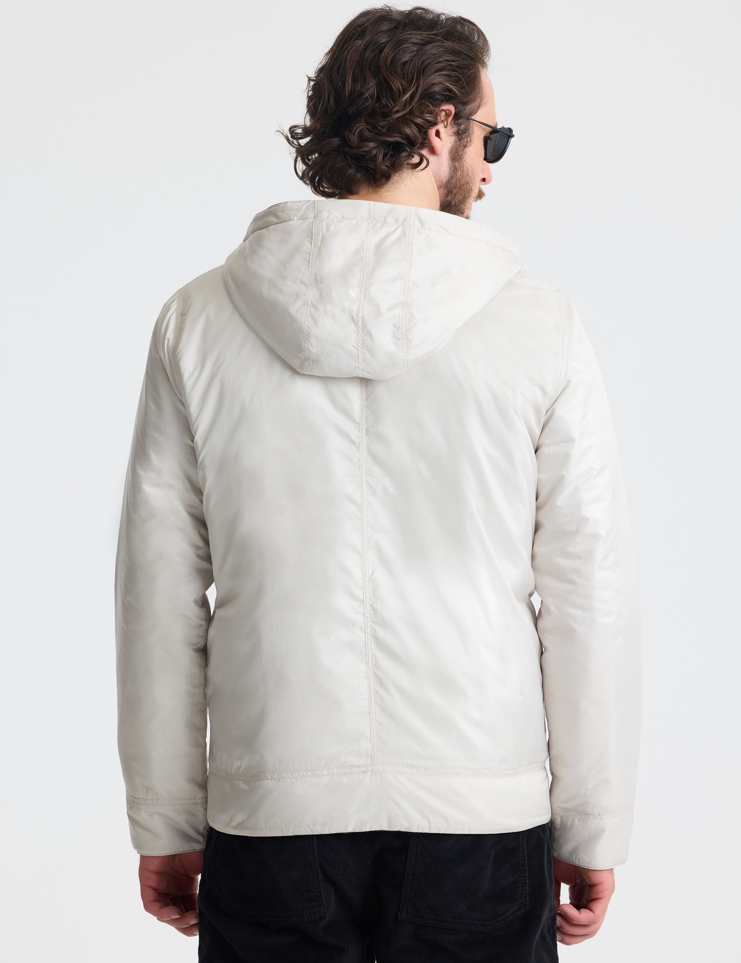 Rear view of man wearing Eco Space Hoodie in Bone white from AETHER Apparel. 