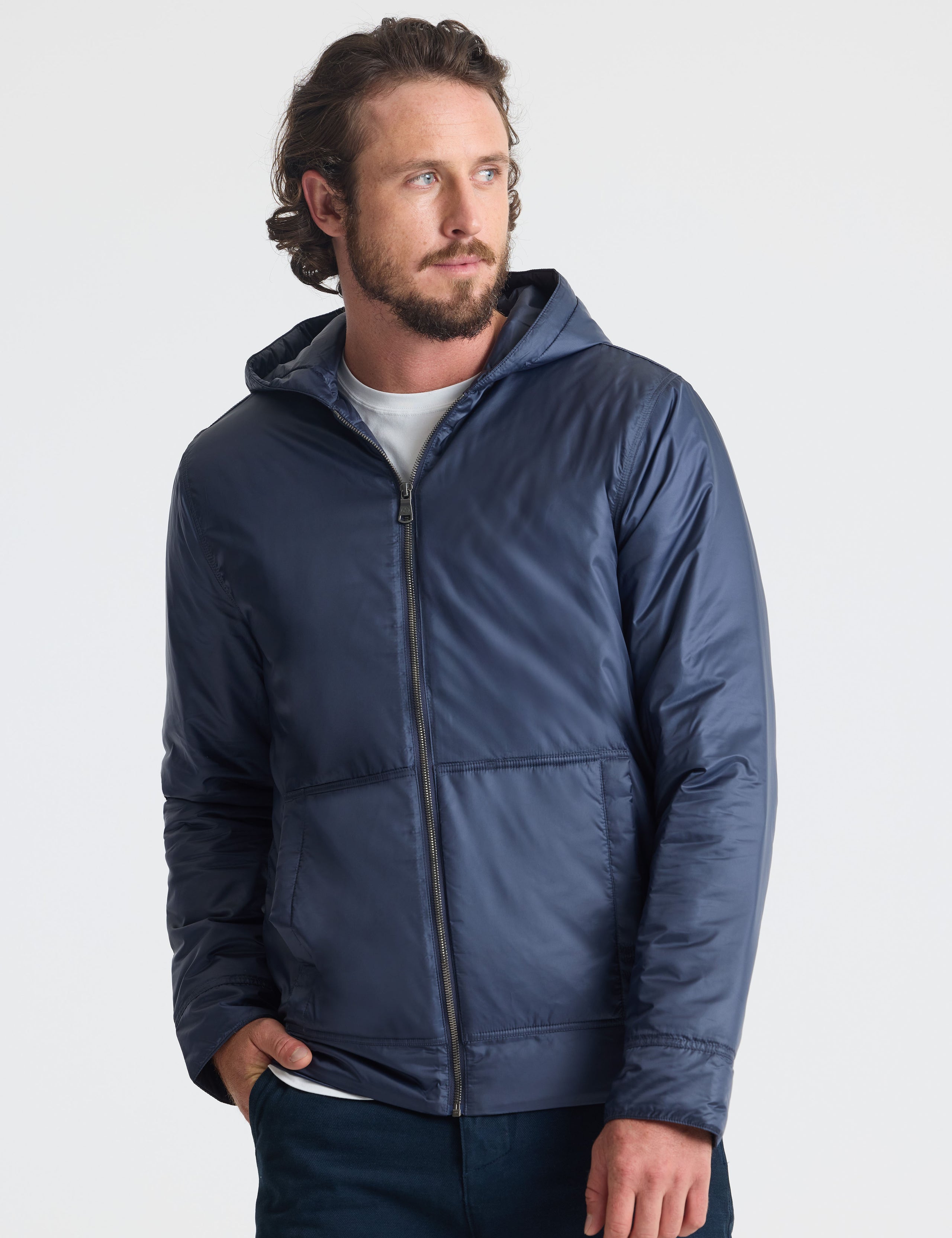 Front view of man wearing unzipped Eco Space Hoodie in Total Eclipse dark blue from AETHER Apparel.
