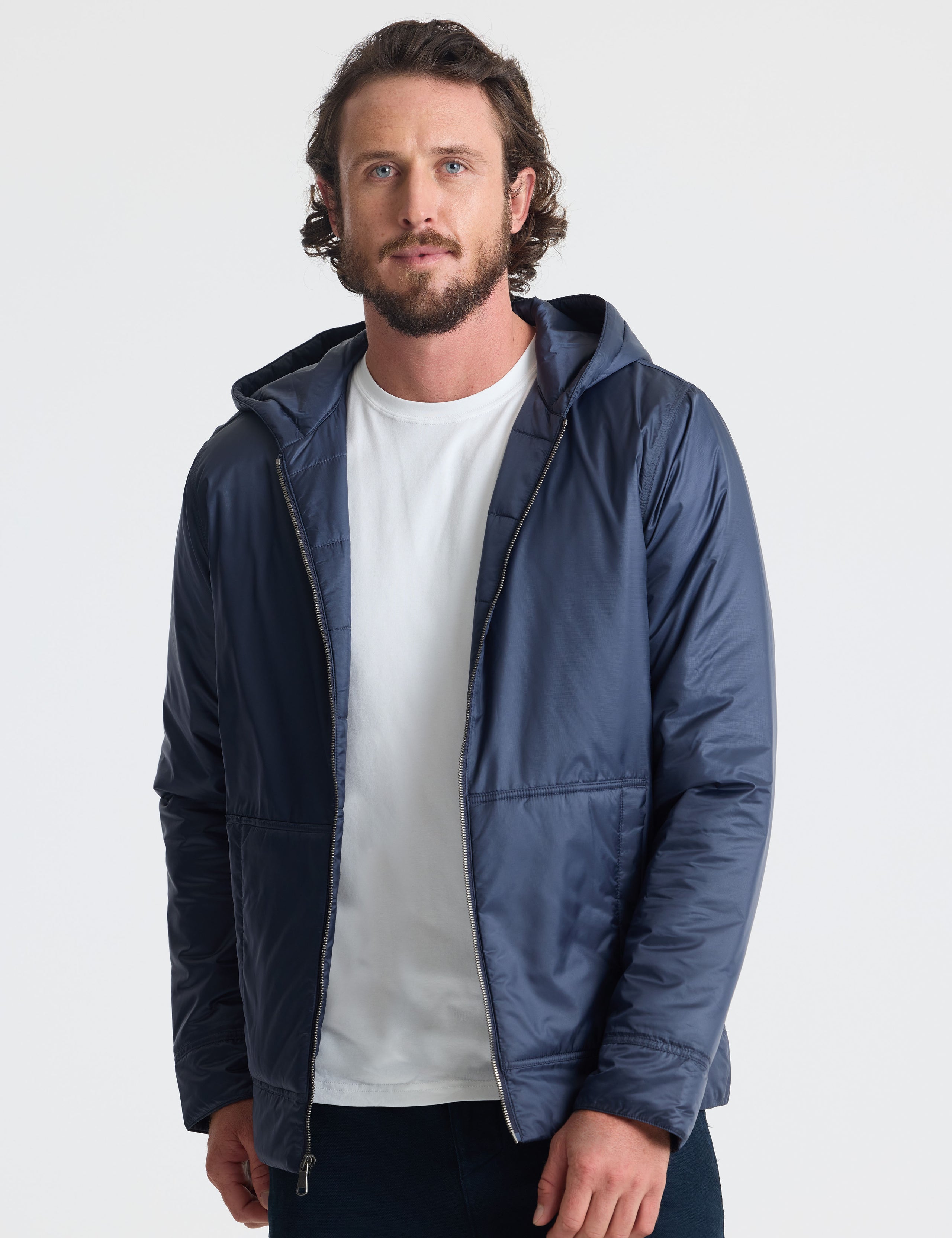 Front view of man wearing unzipped Eco Space Hoodie in Total Eclipse dark blue from AETHER Apparel.