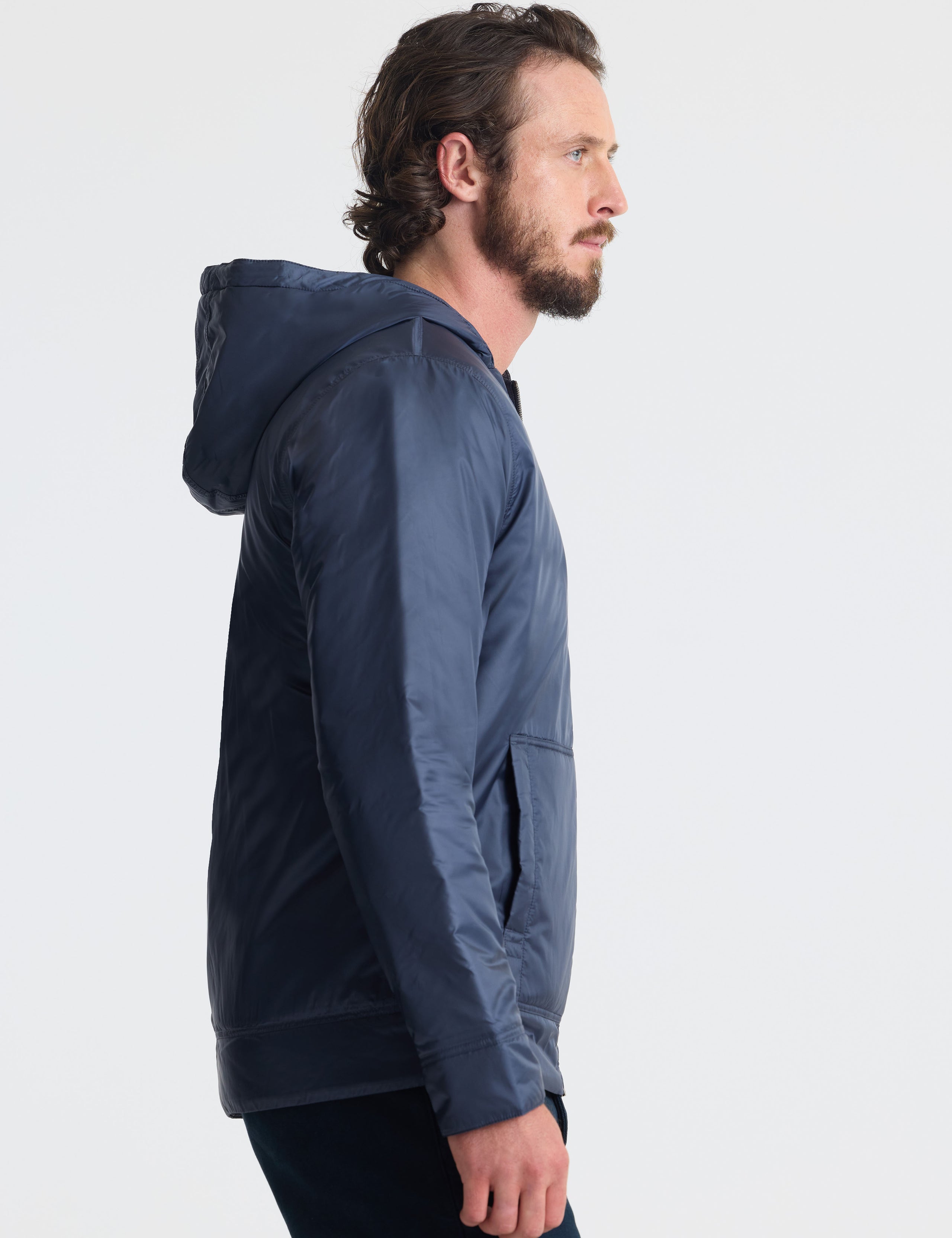Right profile view of man wearing Eco Space Hoodie in Total Eclipse dark blue from AETHER Apparel.