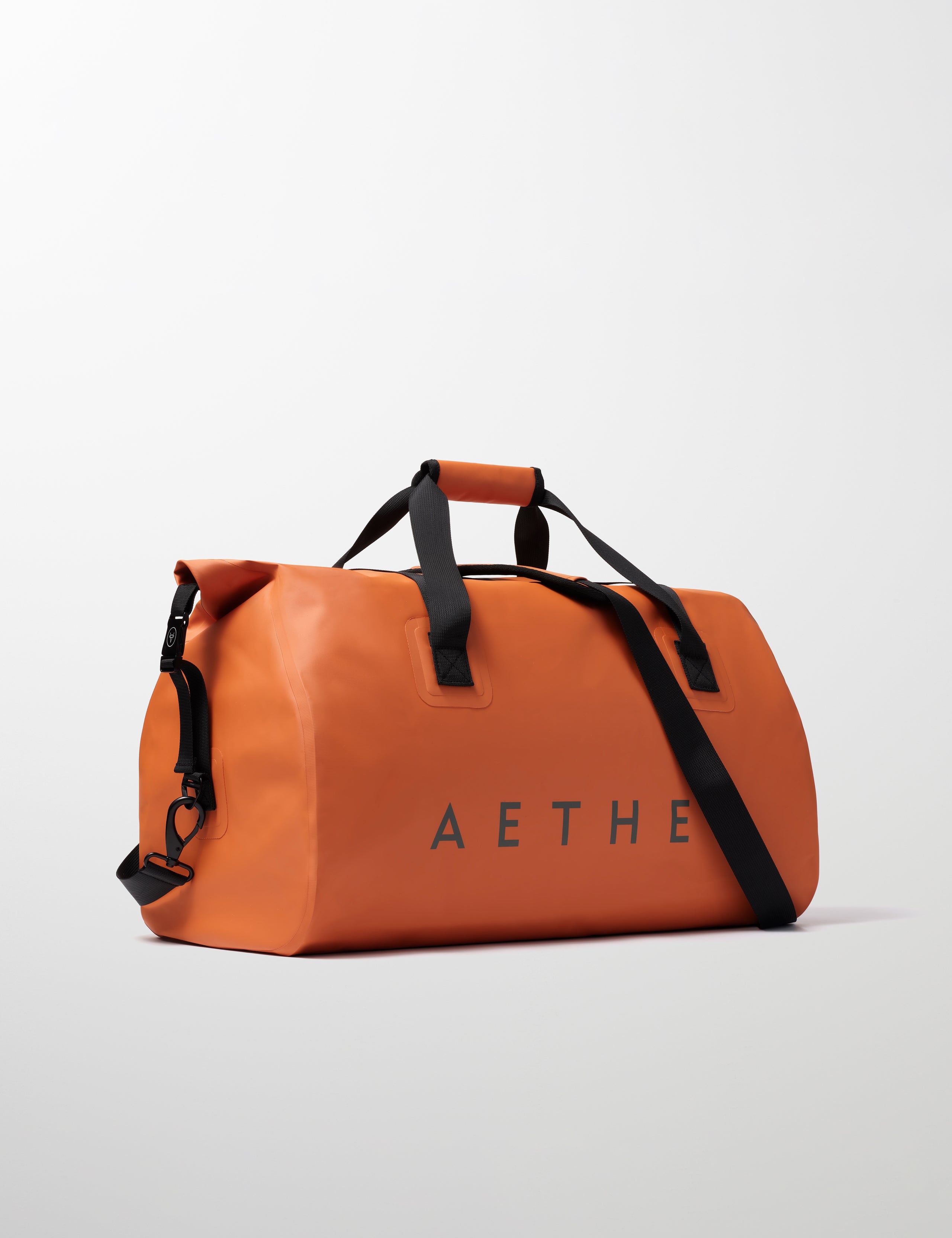 Front angled view of Excursion Duffle Bag 60L in Autumn Orange from AETHER Apparel.
