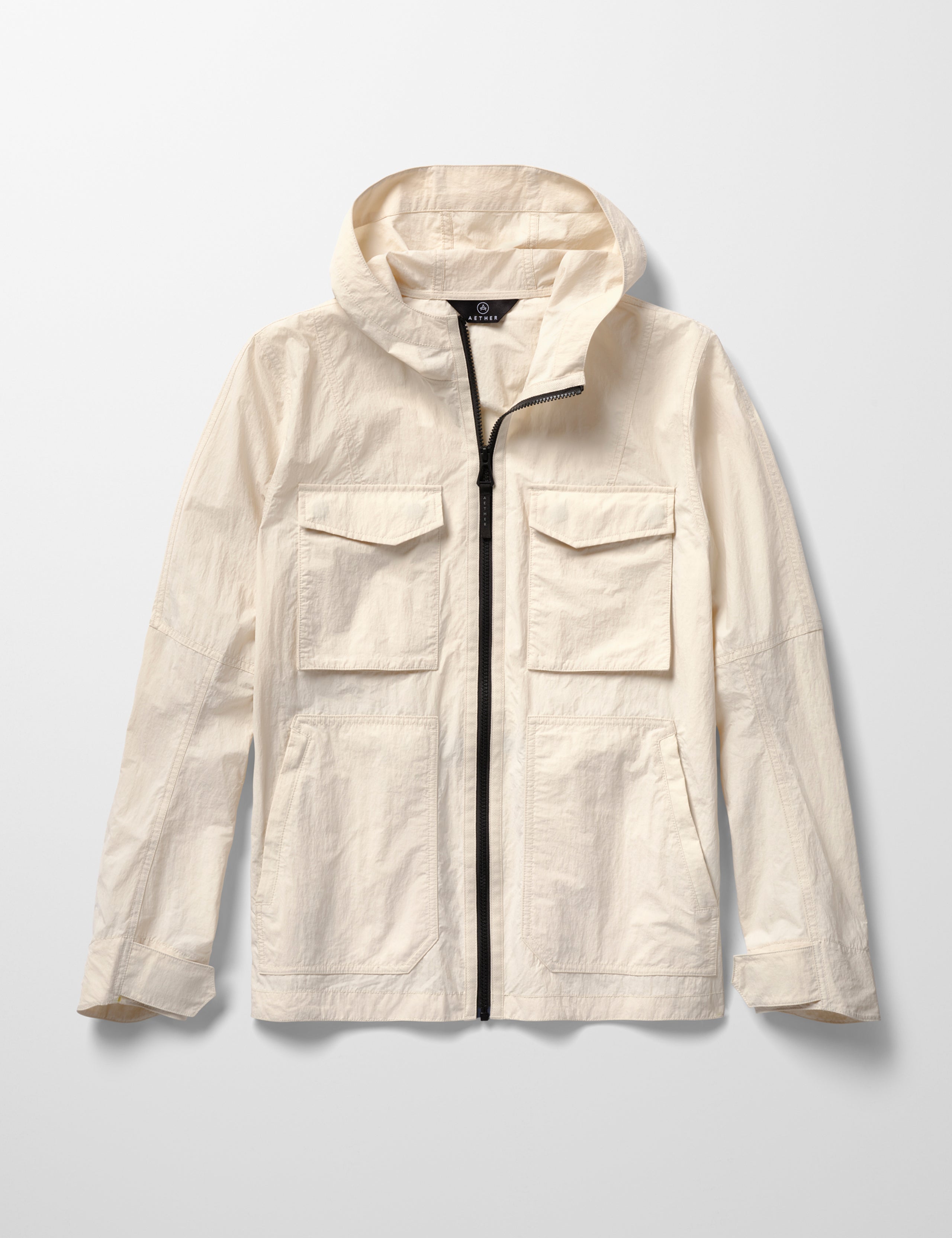 Flat lay image of men's Aires Lightweight Windbreaker in Bone white from AETHER Apparel.