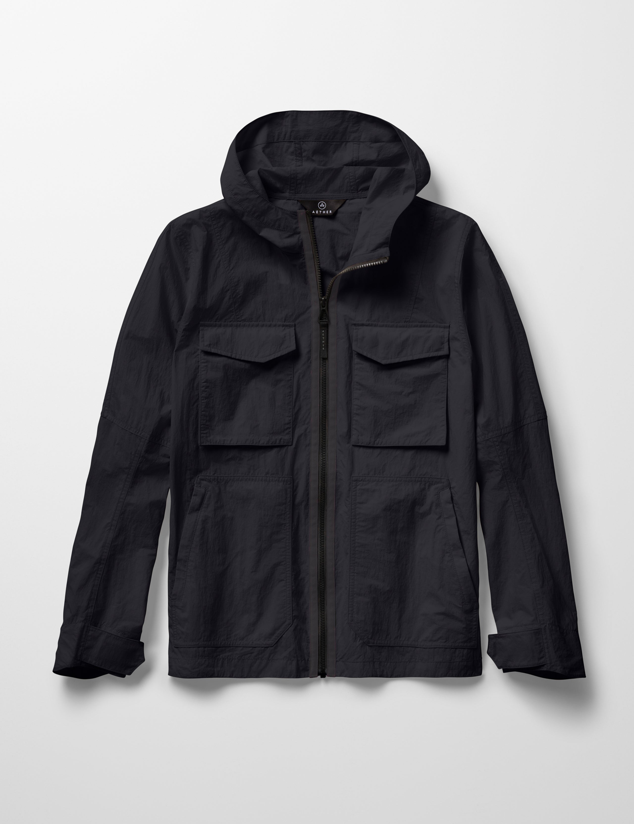 Flat lay image of the Aires Lightweight Windbreaker in Onyx Black from AETHER Apparel.