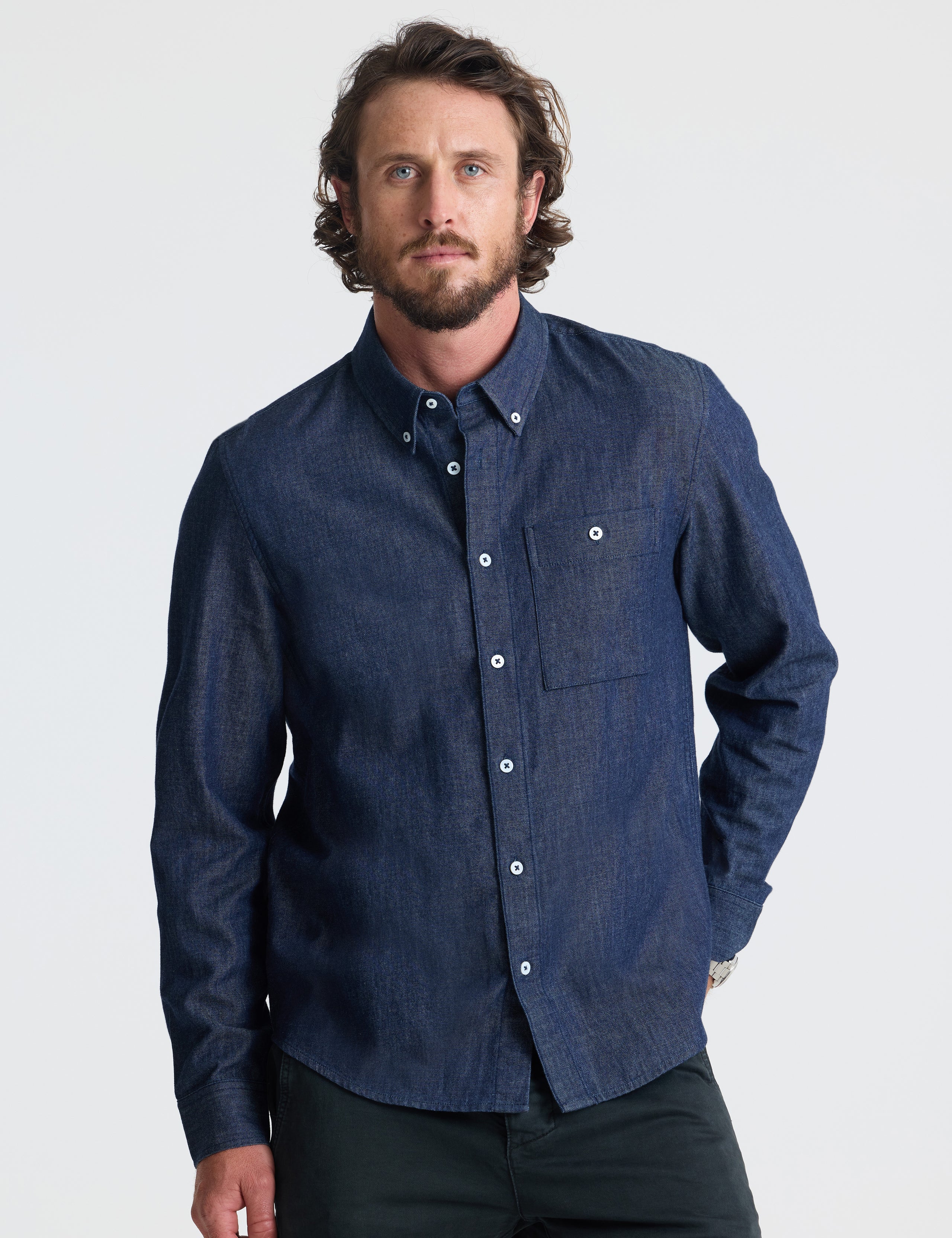 Front view of man wearing Alder Chambray Button-Down in Dark Blue from AETHER Apparel.