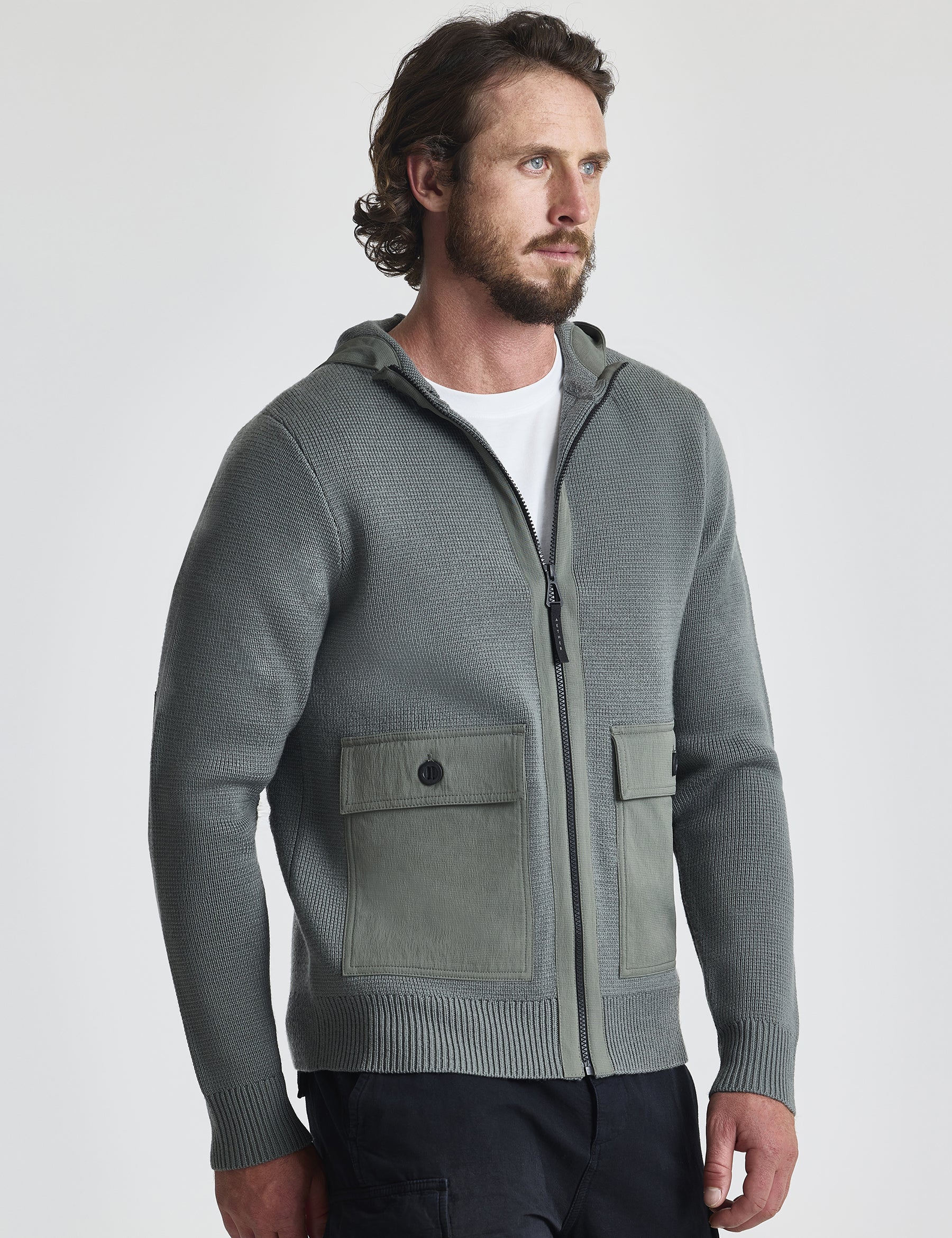Angled view of man wearing Benson Full-Zip Sweater in Gunmetal grey from AETHER Apparel.