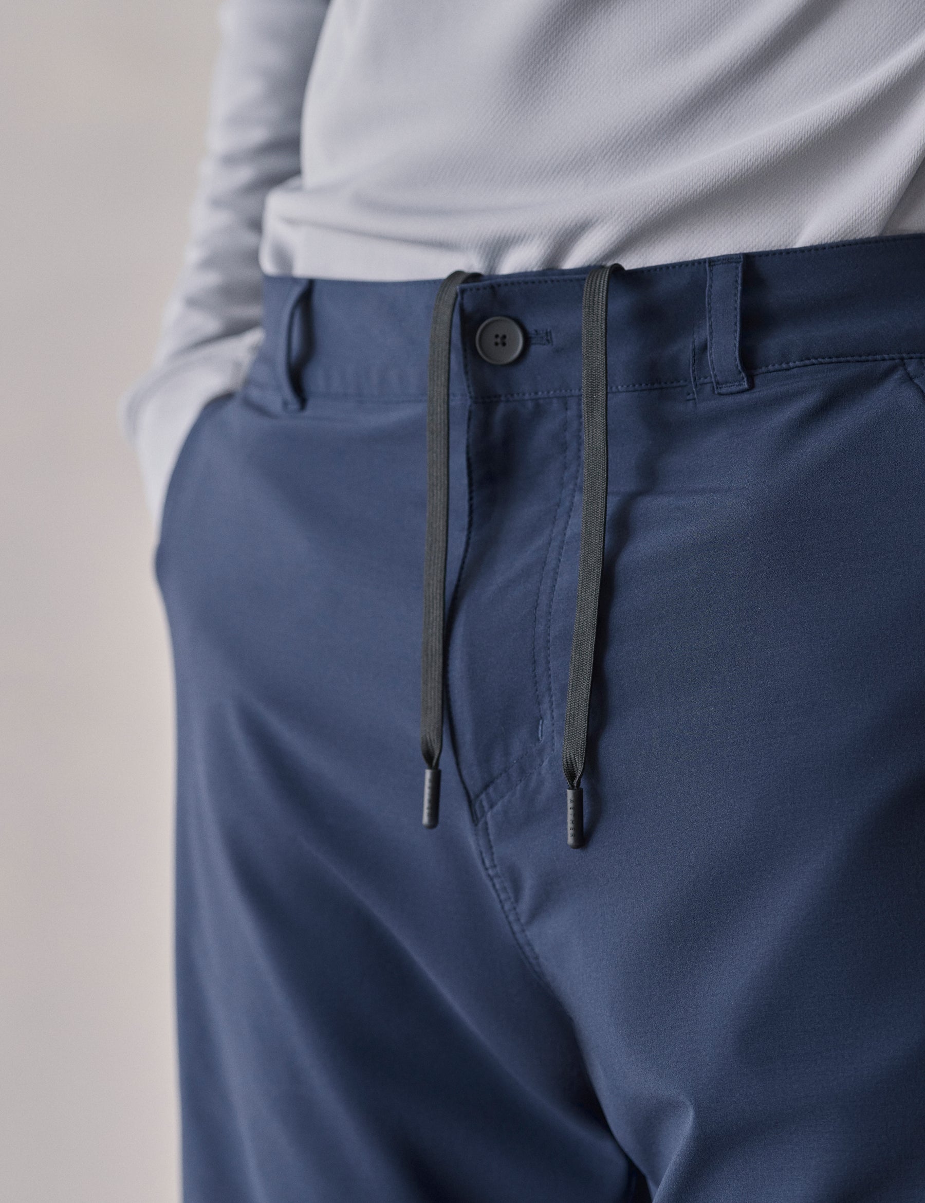 Closeup detailed shot of front closure and drawcord on Catalina Submersible Short in Total Eclipse dark blue from AETHER Apparel.