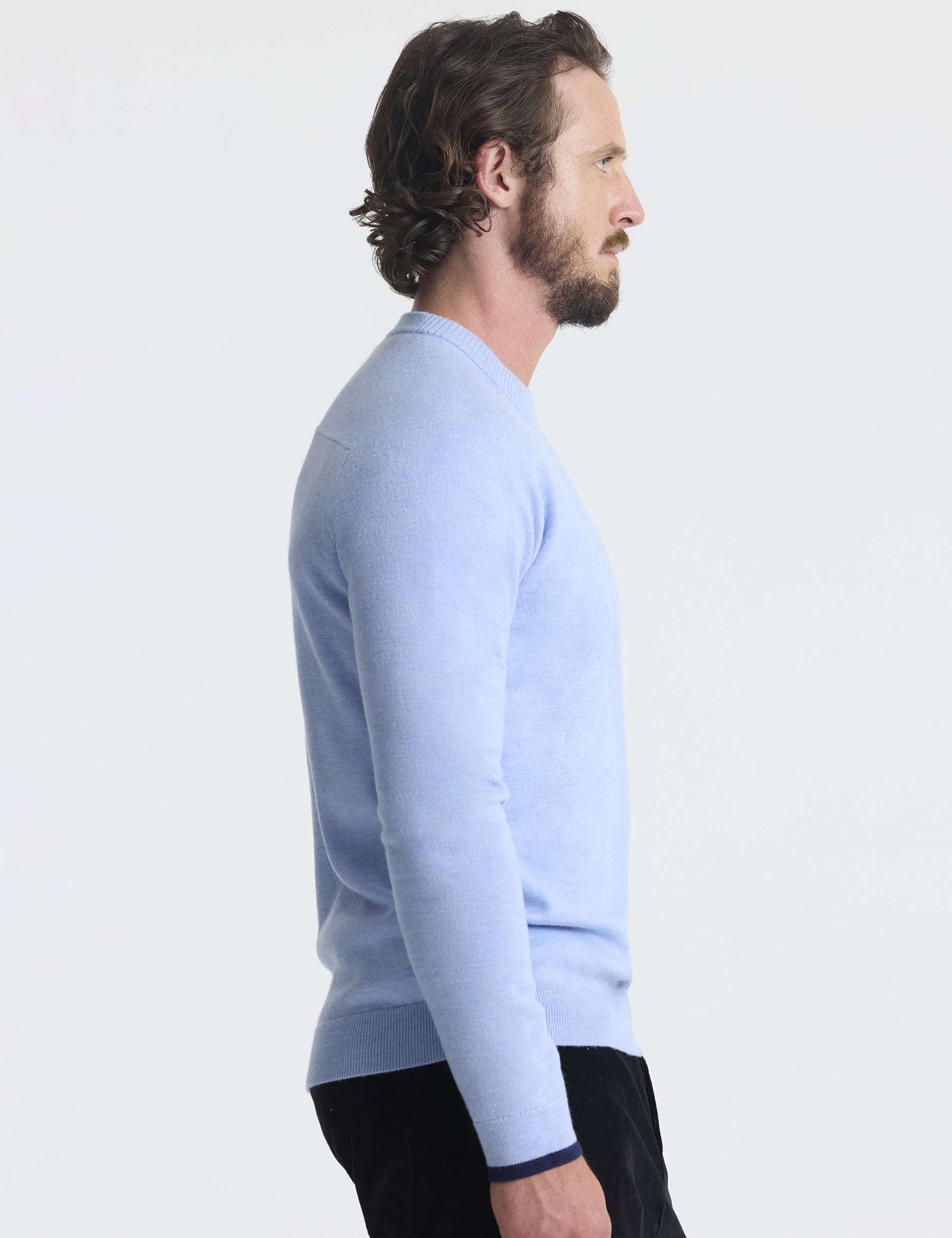 Right profile view of man wearing Corbin Sweater in Light Blue Heather from AETHER Apparel.
