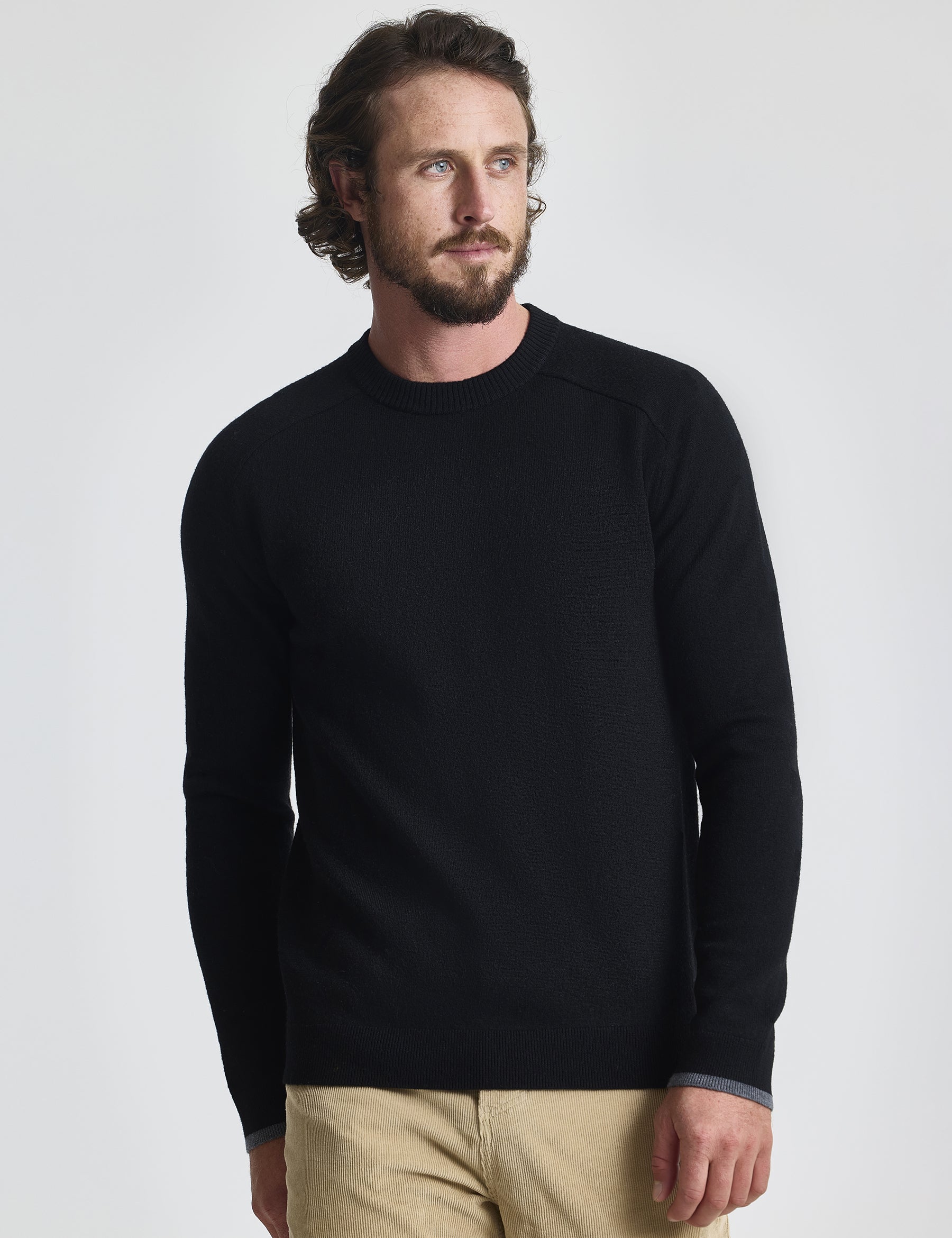 Front view of man wearing Corbin Sweater in Onyx Black from AETHER Apparel. 