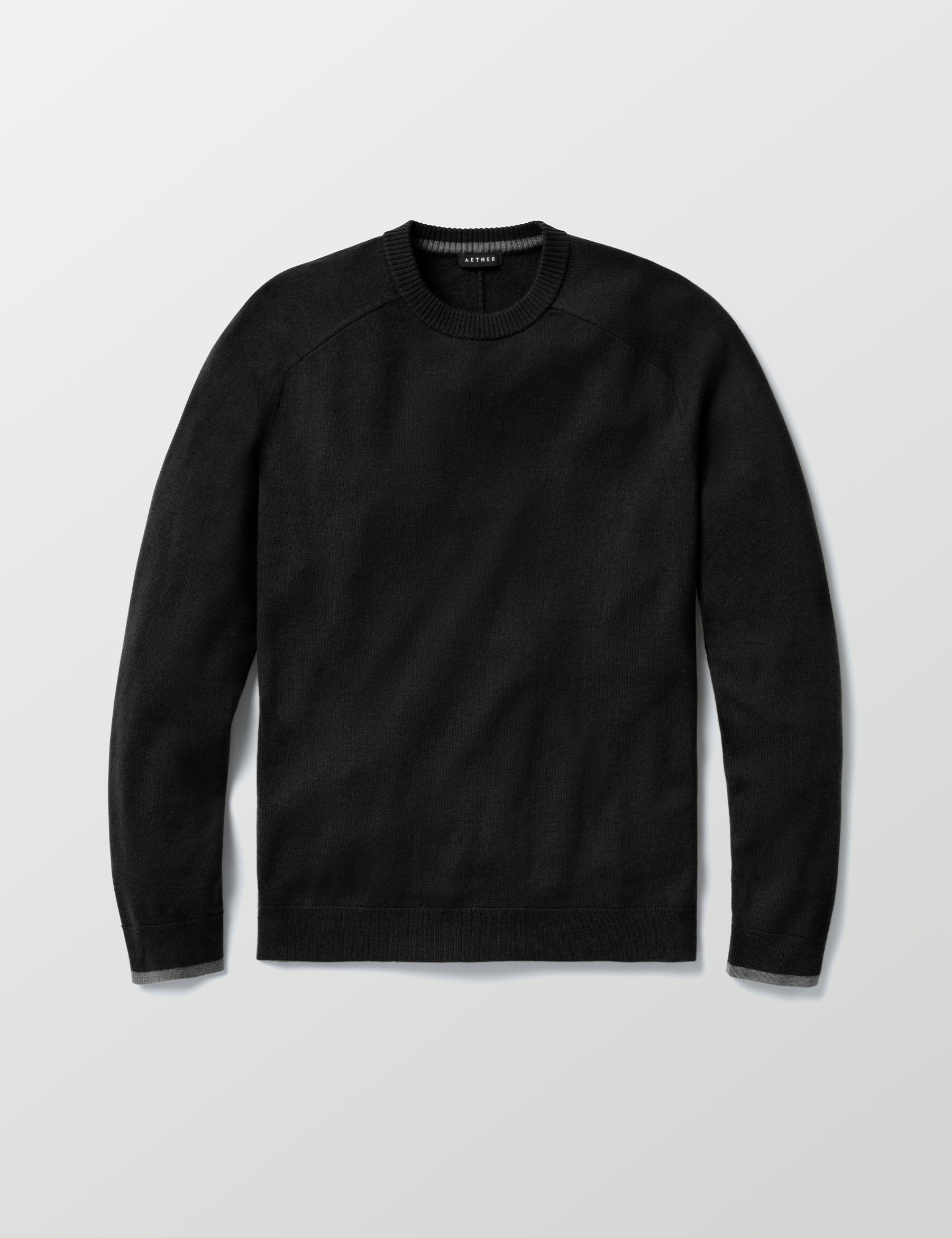 Flat lay of Corbin Sweater in Onyx Black from AETHER Apparel. 