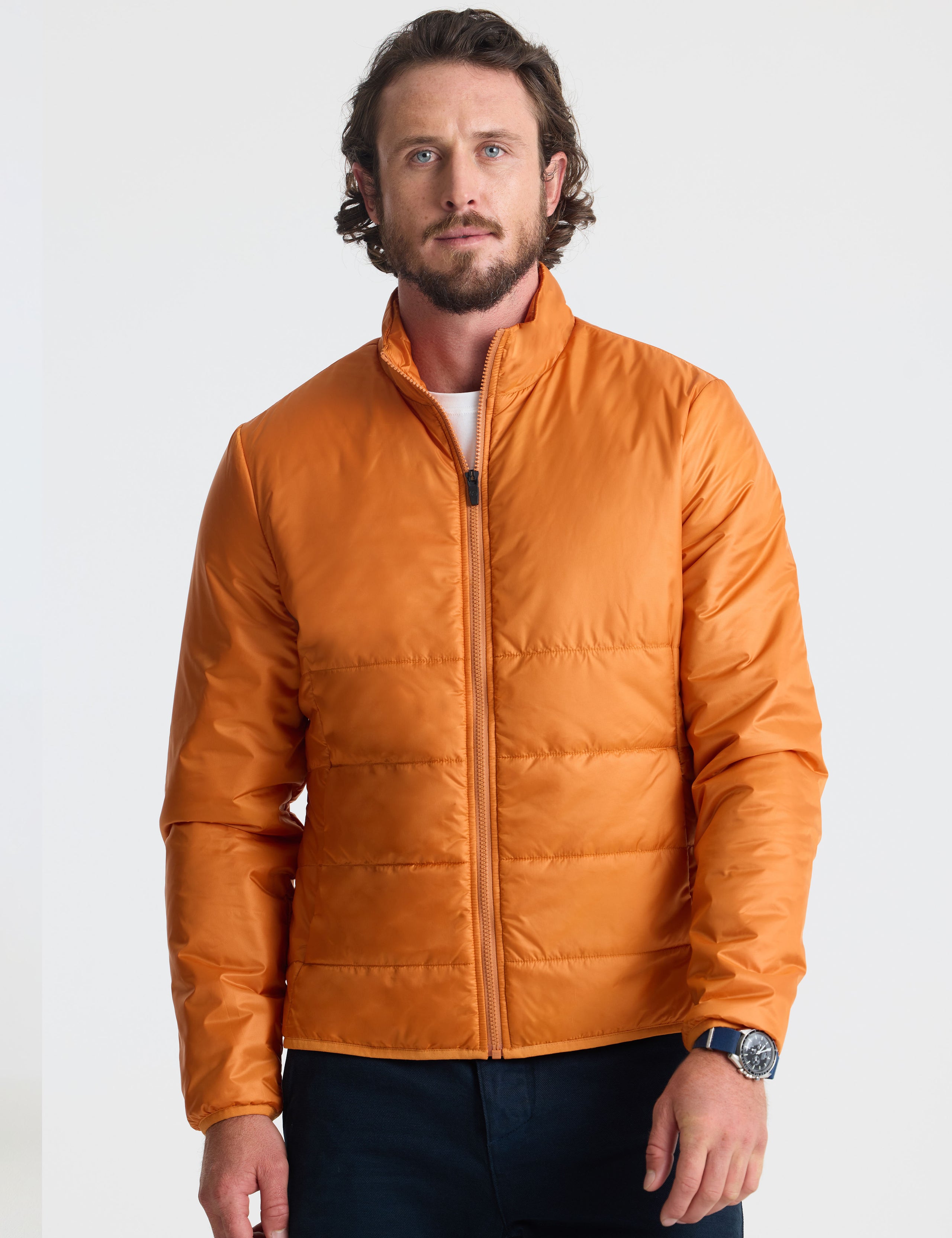 Front view of man wearing Eco Insulated Jacket in Autumn Orange from AETHER Apparel.