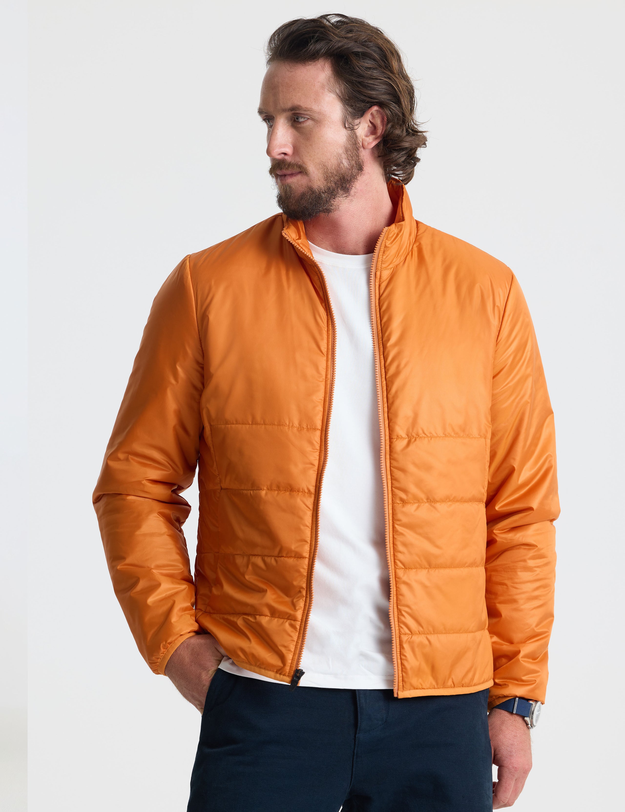 Front view of man wearing unzipped Eco Insulated Jacket in Autumn Orange from AETHER Apparel.