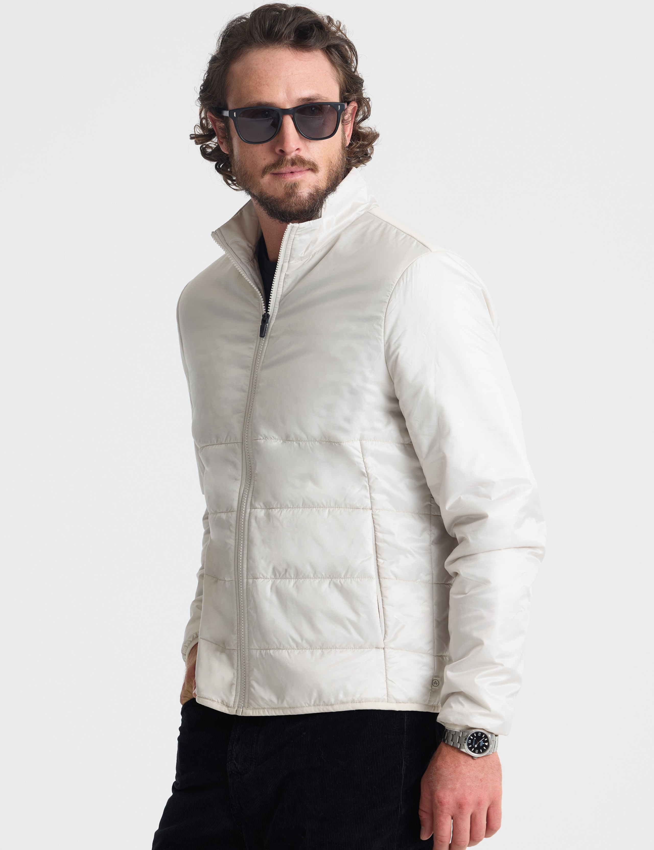 Front angled view of man wearing Eco Insulated Jacket in Bone white from AETHER Apparel.