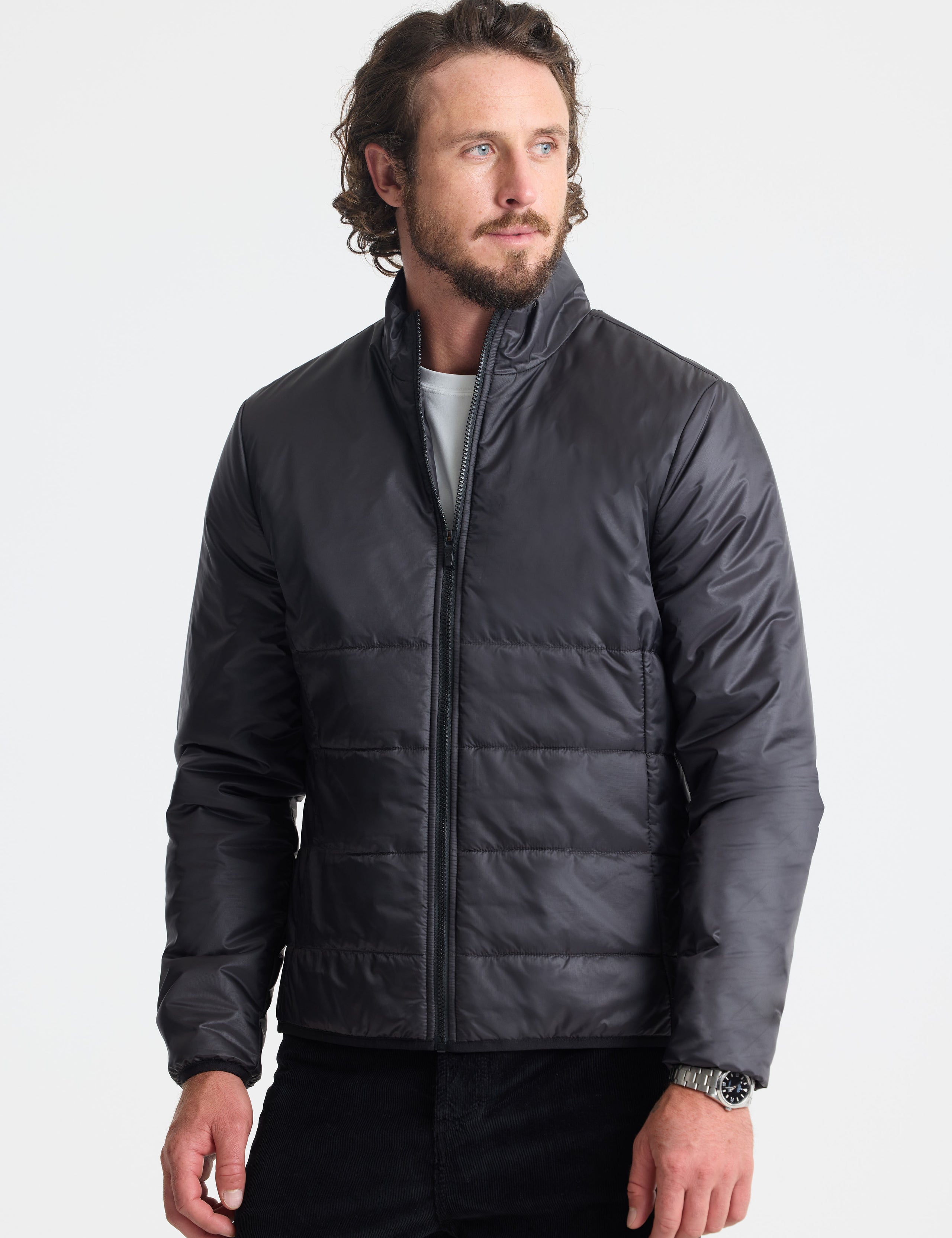 Front view of man wearing Eco Insulated Jacket in Onyx Black from AETHER Apparel.