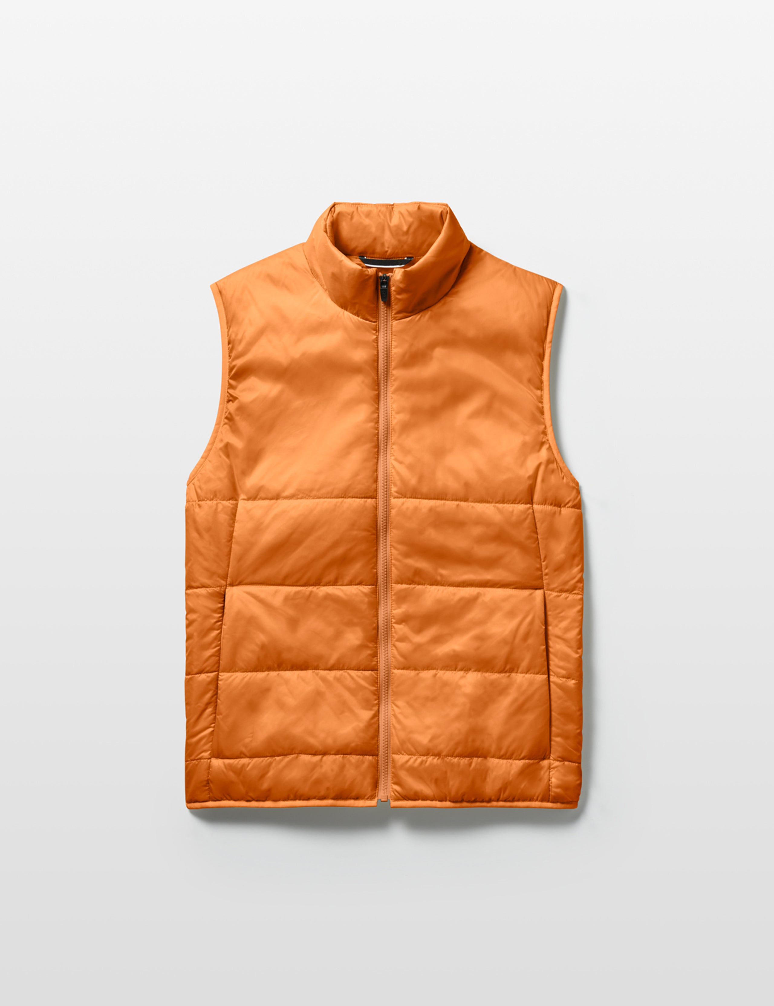 Flat lay of Eco Insulated Vest in Autumn Orange from AETHER Apparel.