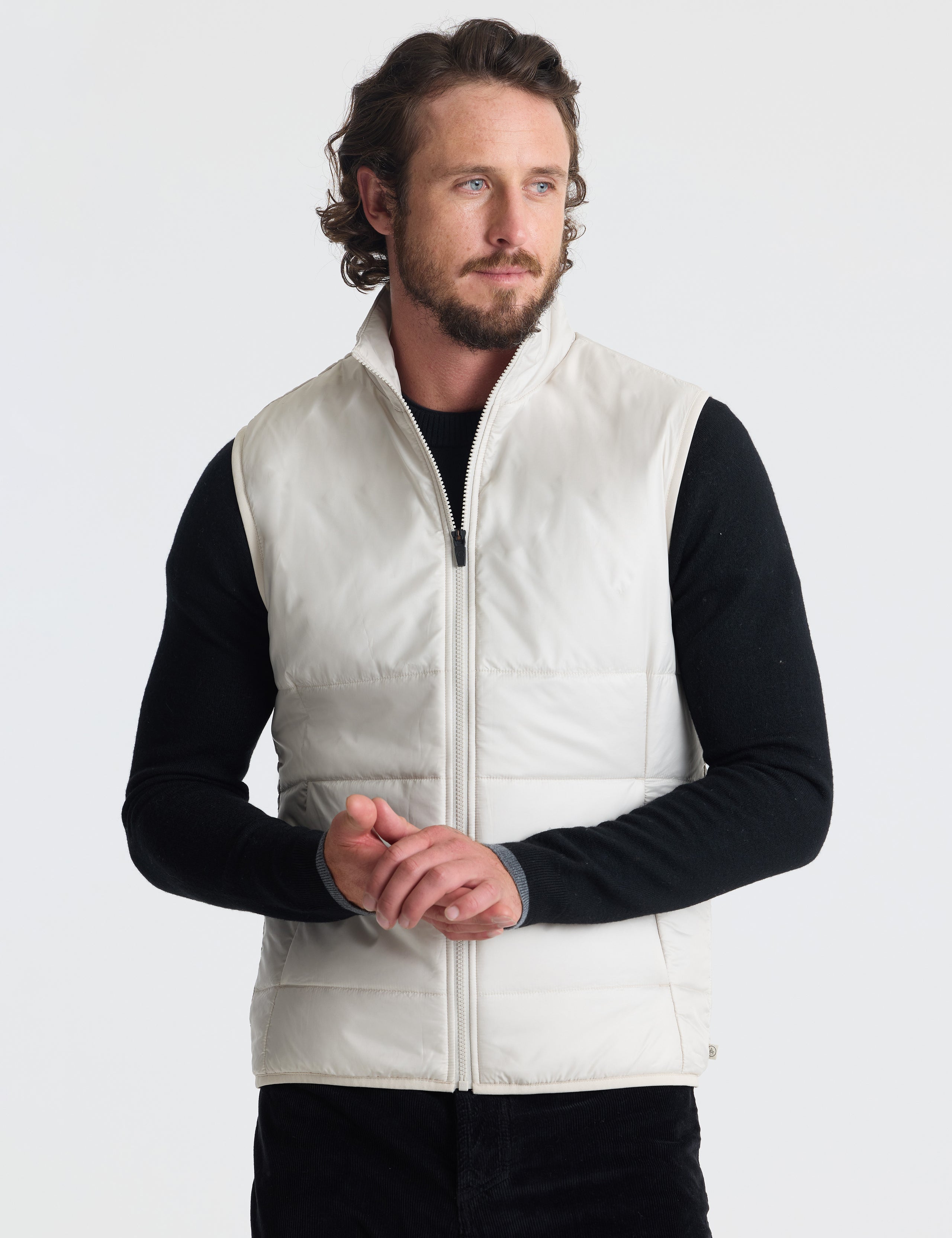 Front view of man wearing Eco Insulated Vest in Bone white from AETHER Apparel.