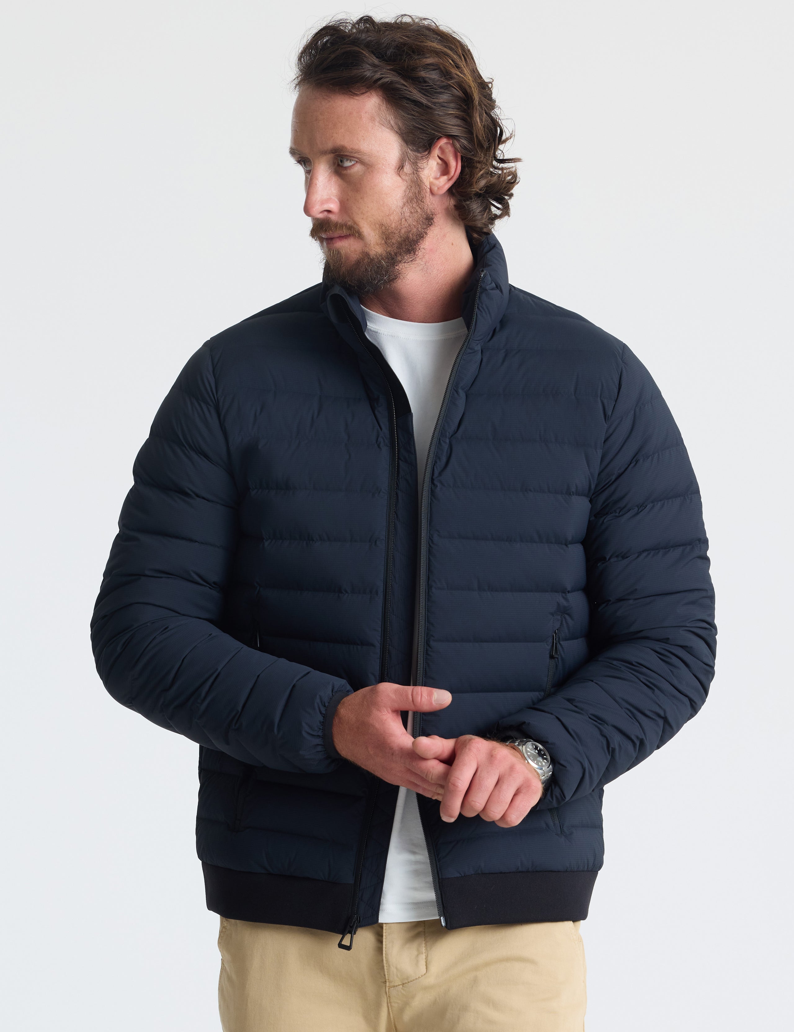 Front view of man wearing unzipped Launch Jacket in Onyx Black from AETHER Apparel.