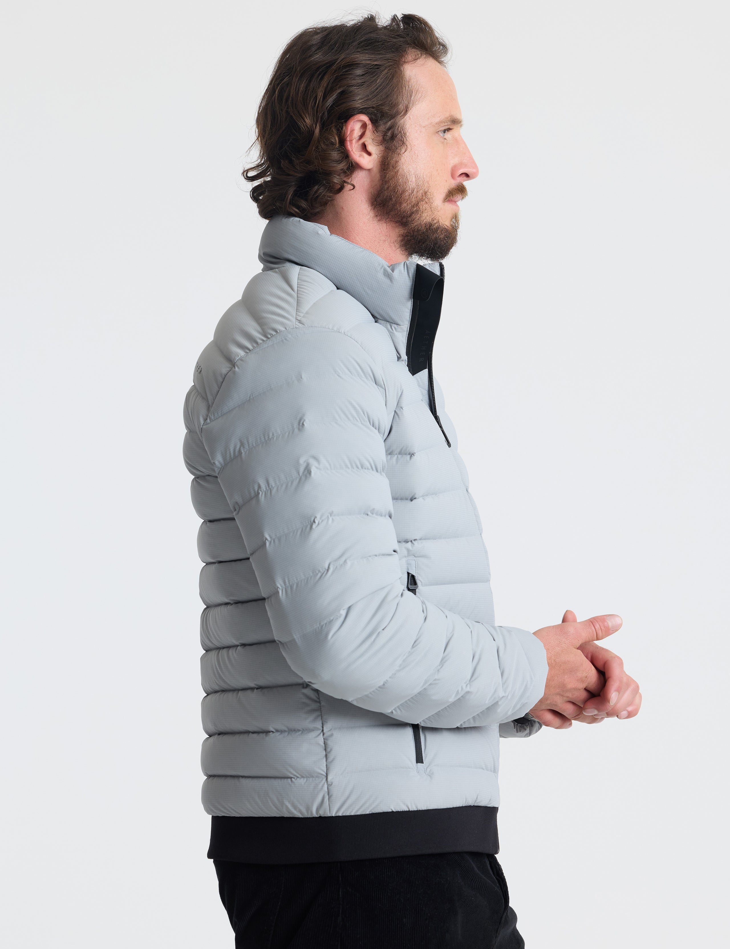 Right profile view of man wearing Launch Jacket in Sky Grey from AETHER Apparel.
