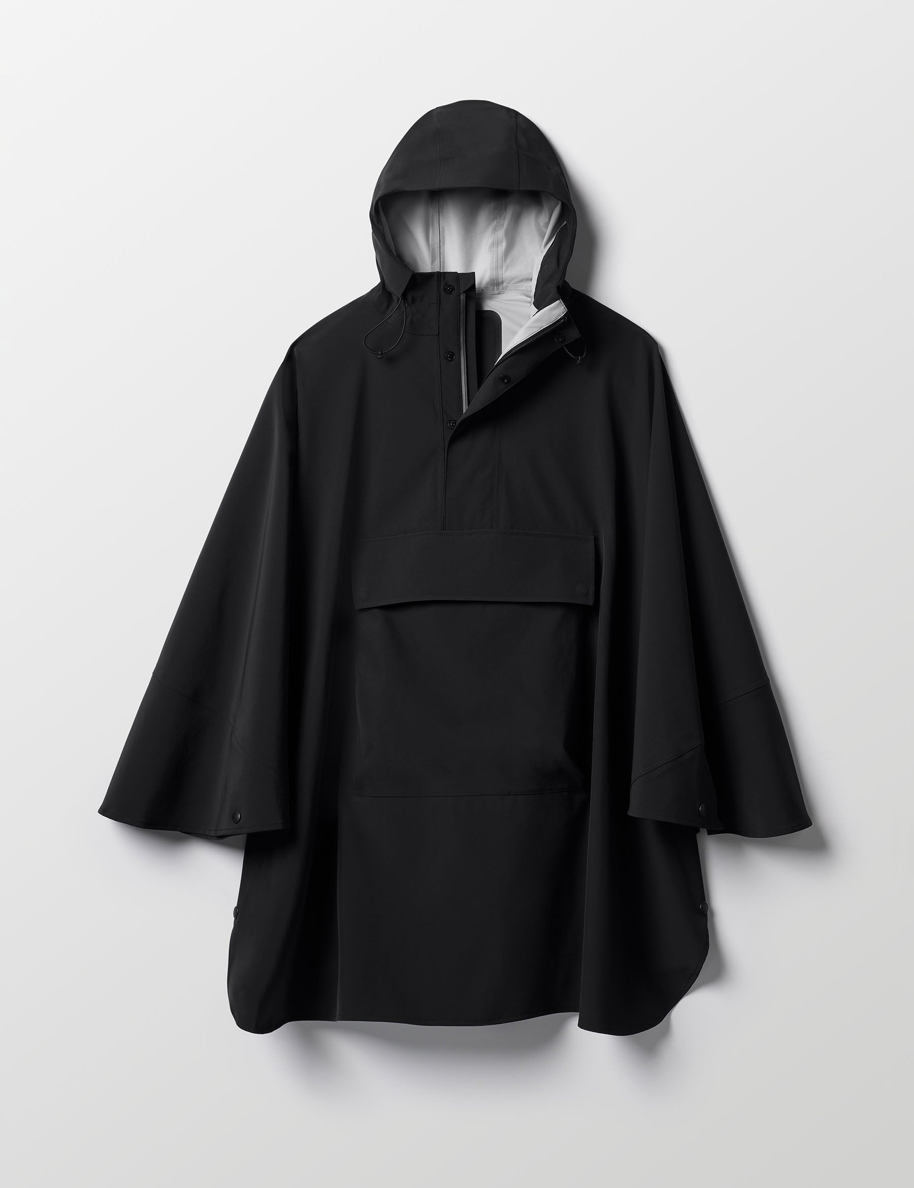 Flat lay of the Line Poncho in Onyx Black from AETHER Apparel.