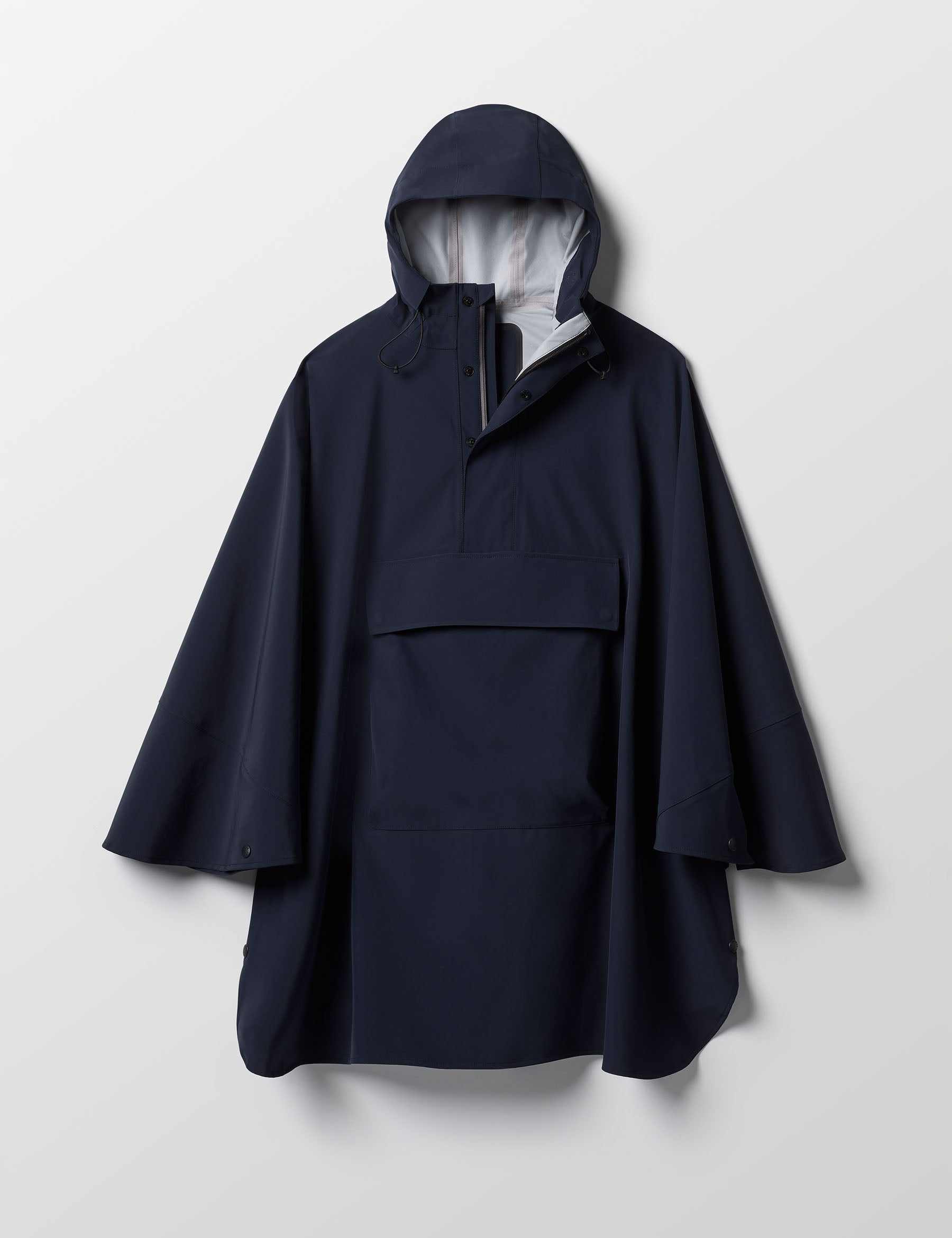 Flat lay of the Line Poncho in Total Eclipse dark blue from AETHER Apparel.