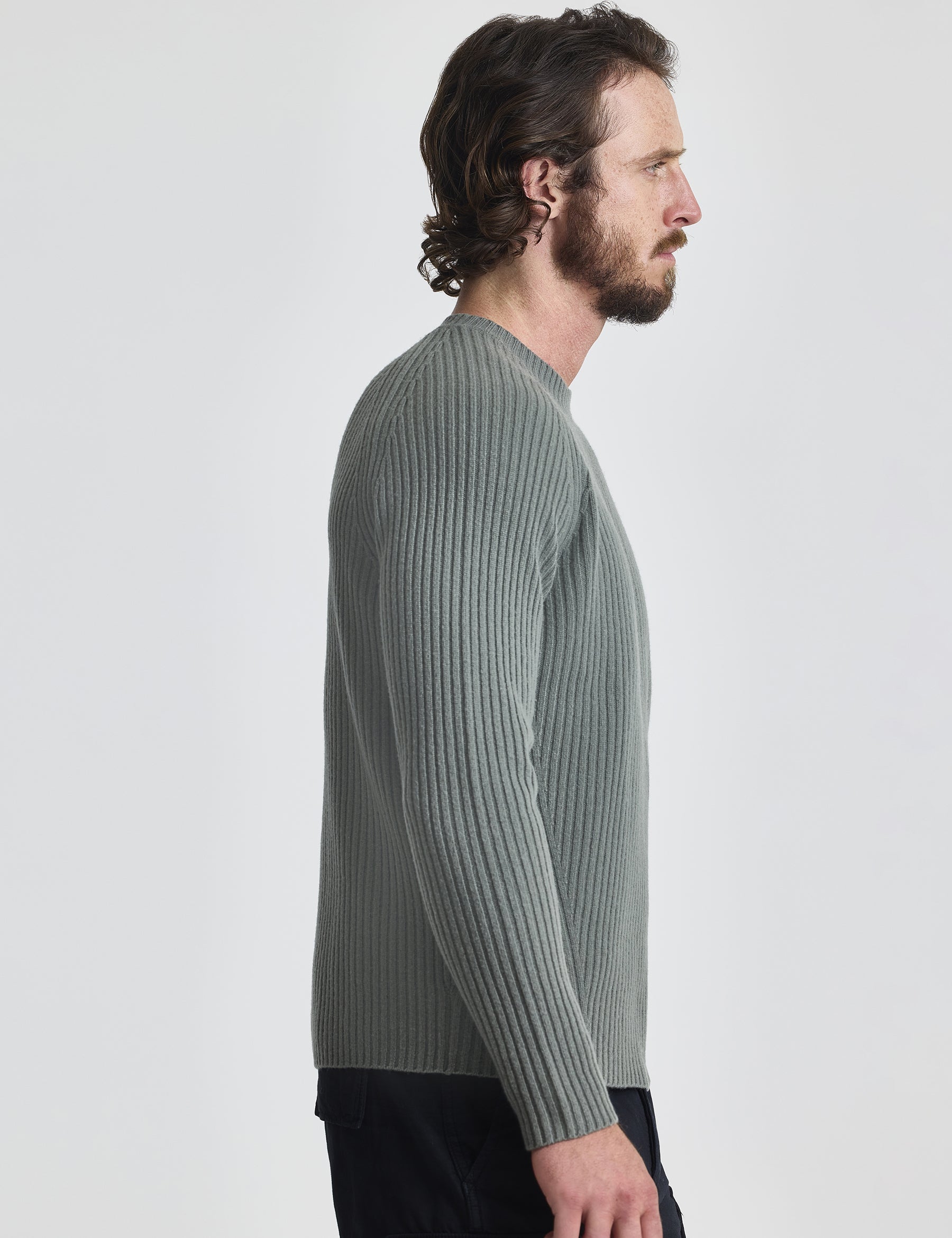 Right profile of man wearing Lyon Sweater in Gunmetal grey from AETHER Apparel.