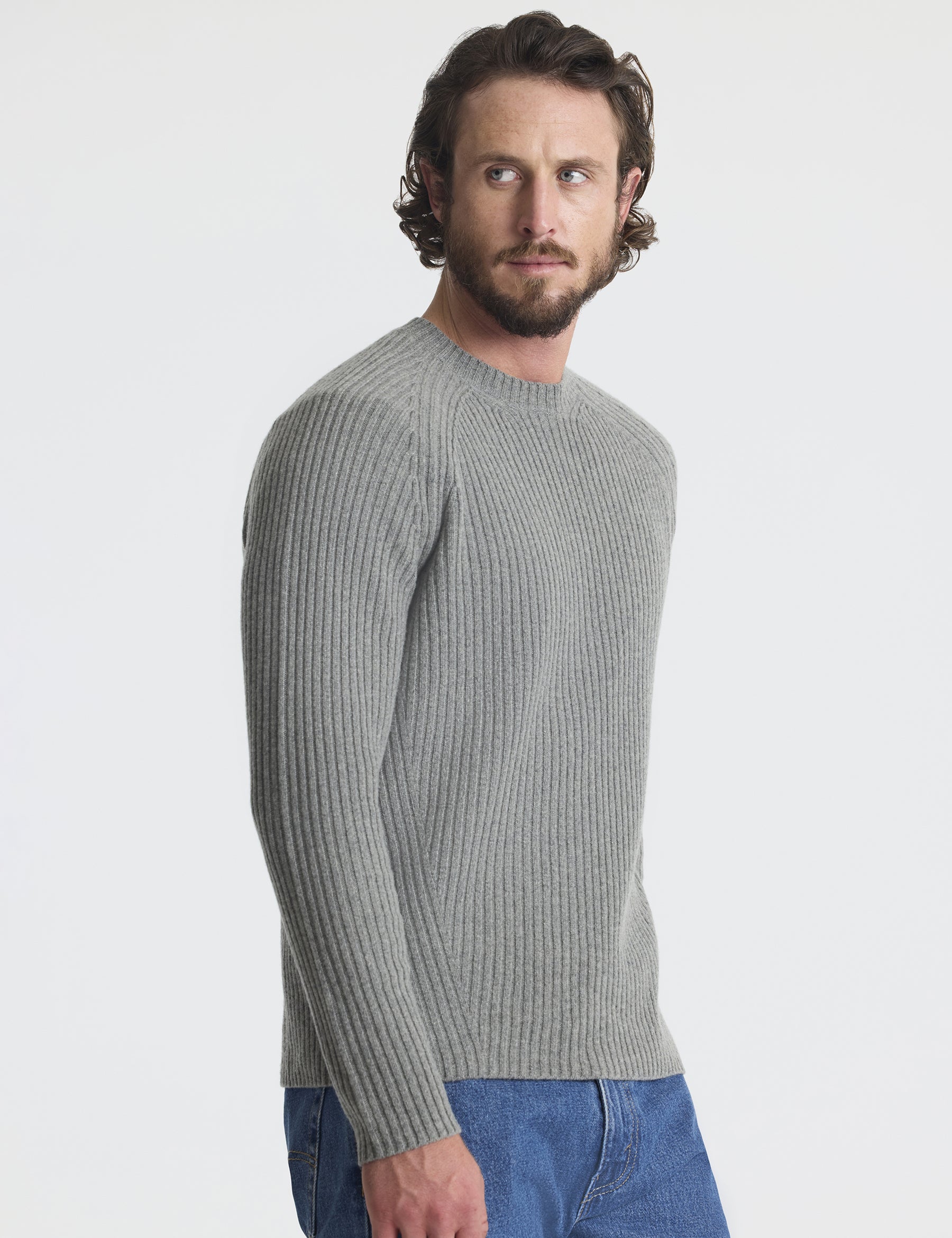 Angled view of man wearing Lyon Sweater in Heather Grey from AETHER Apparel. 