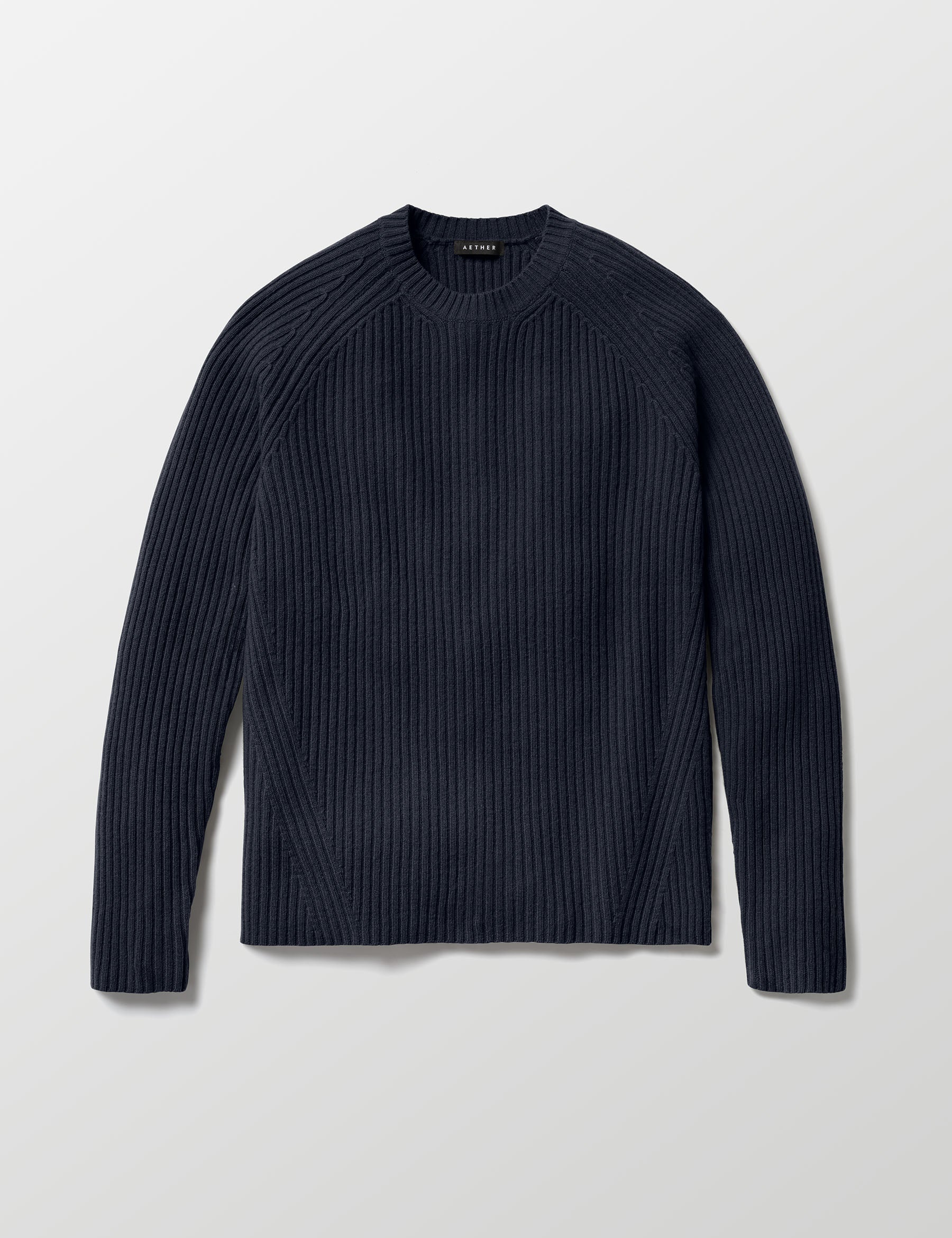 Flat lay of Lyon Sweater in Total Eclipse dark blue from AETHER Apparel. 