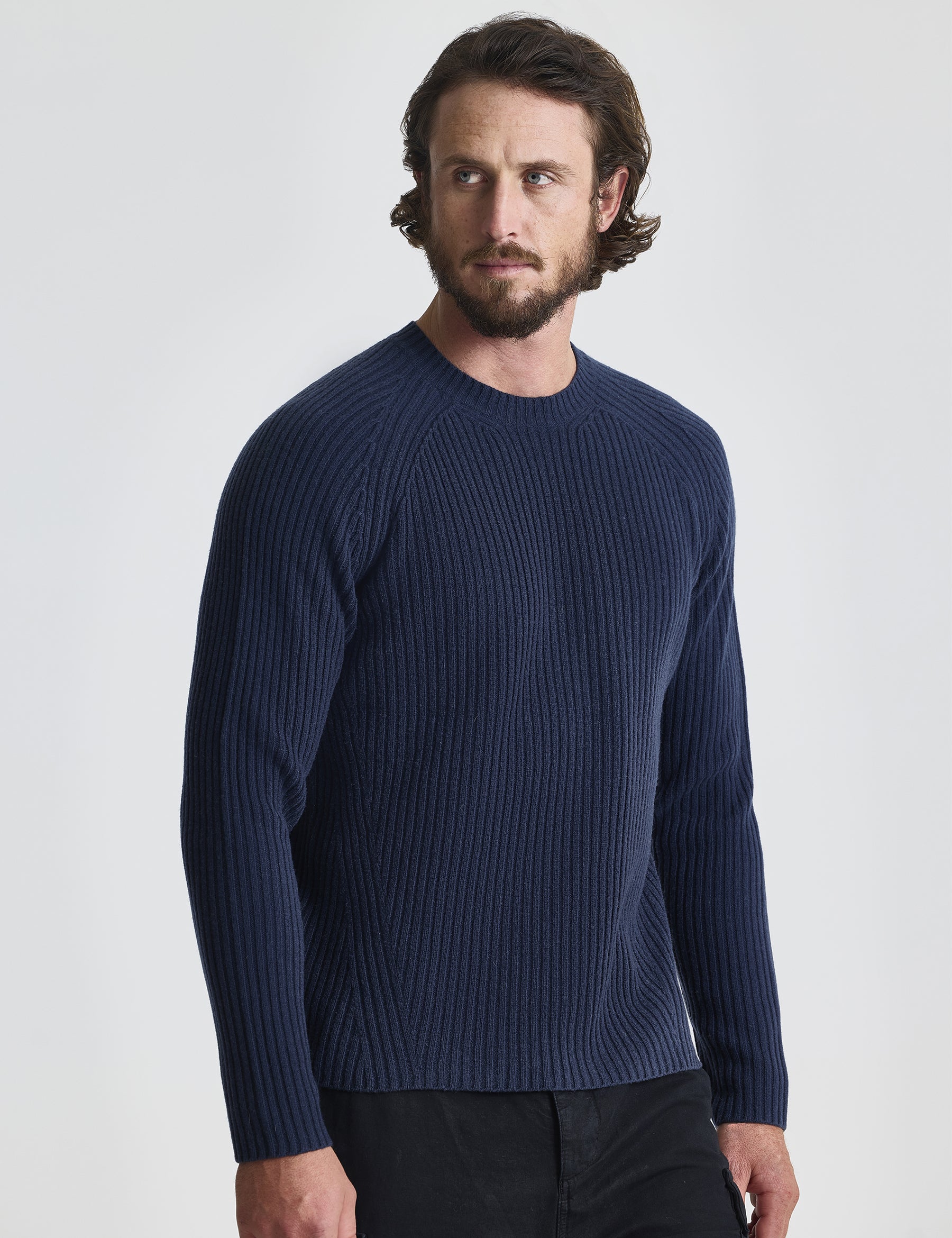 Front view of man wearing Lyon Sweater in Total Eclipse dark blue from AETHER Apparel.