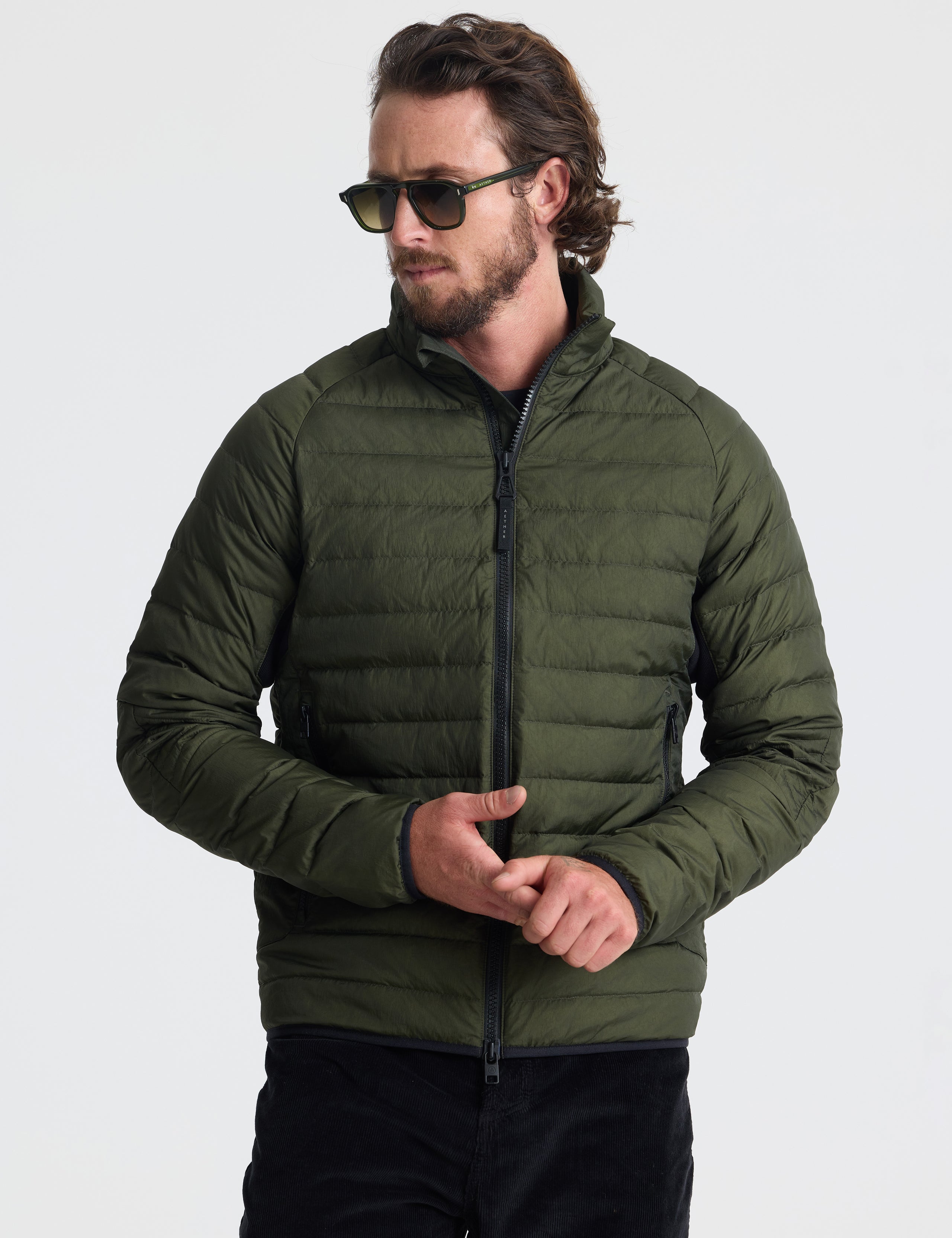 Front view of man wearing Prospect Packable Down Jacket in Forest Green from AETHER Apparel.
