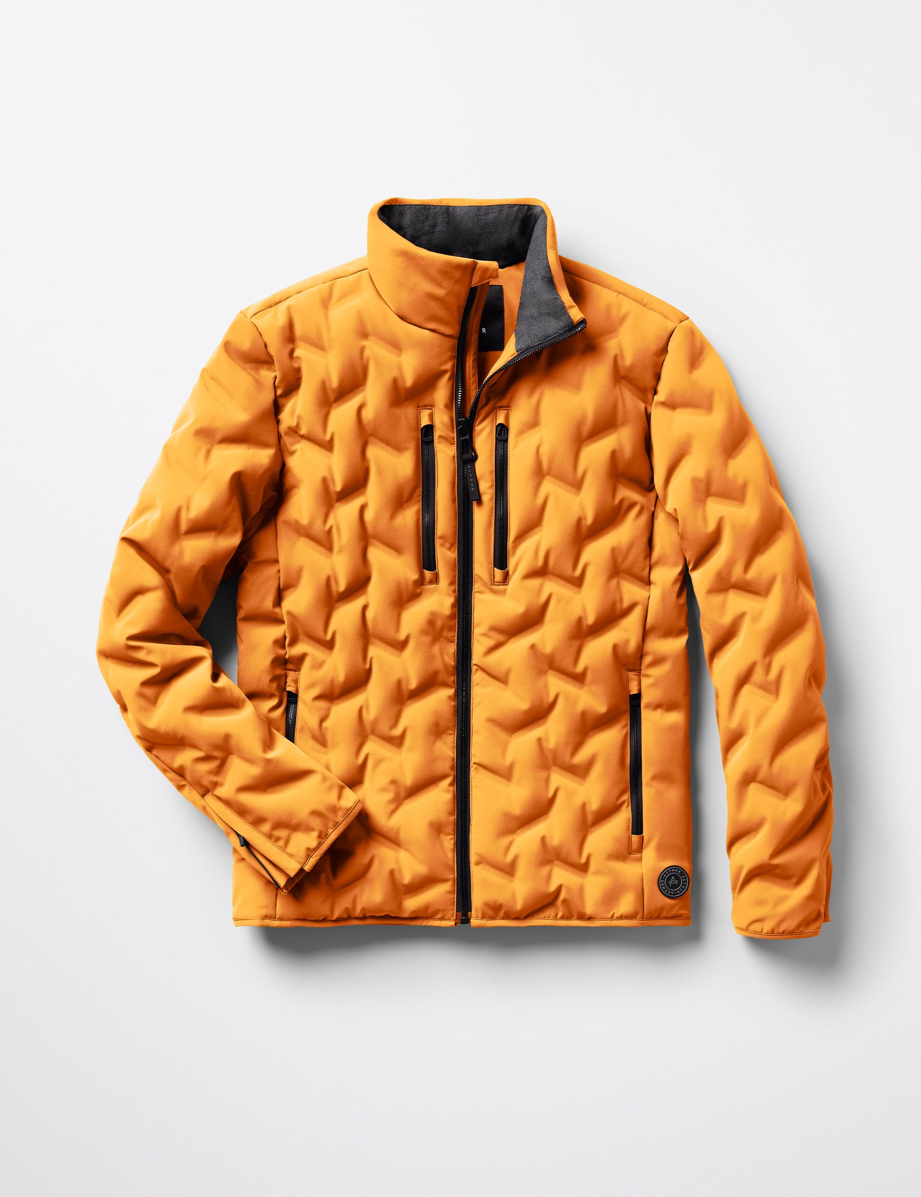 Flat lay of the Rex Down Jacket in Midas Orange from AETHER Apparel.