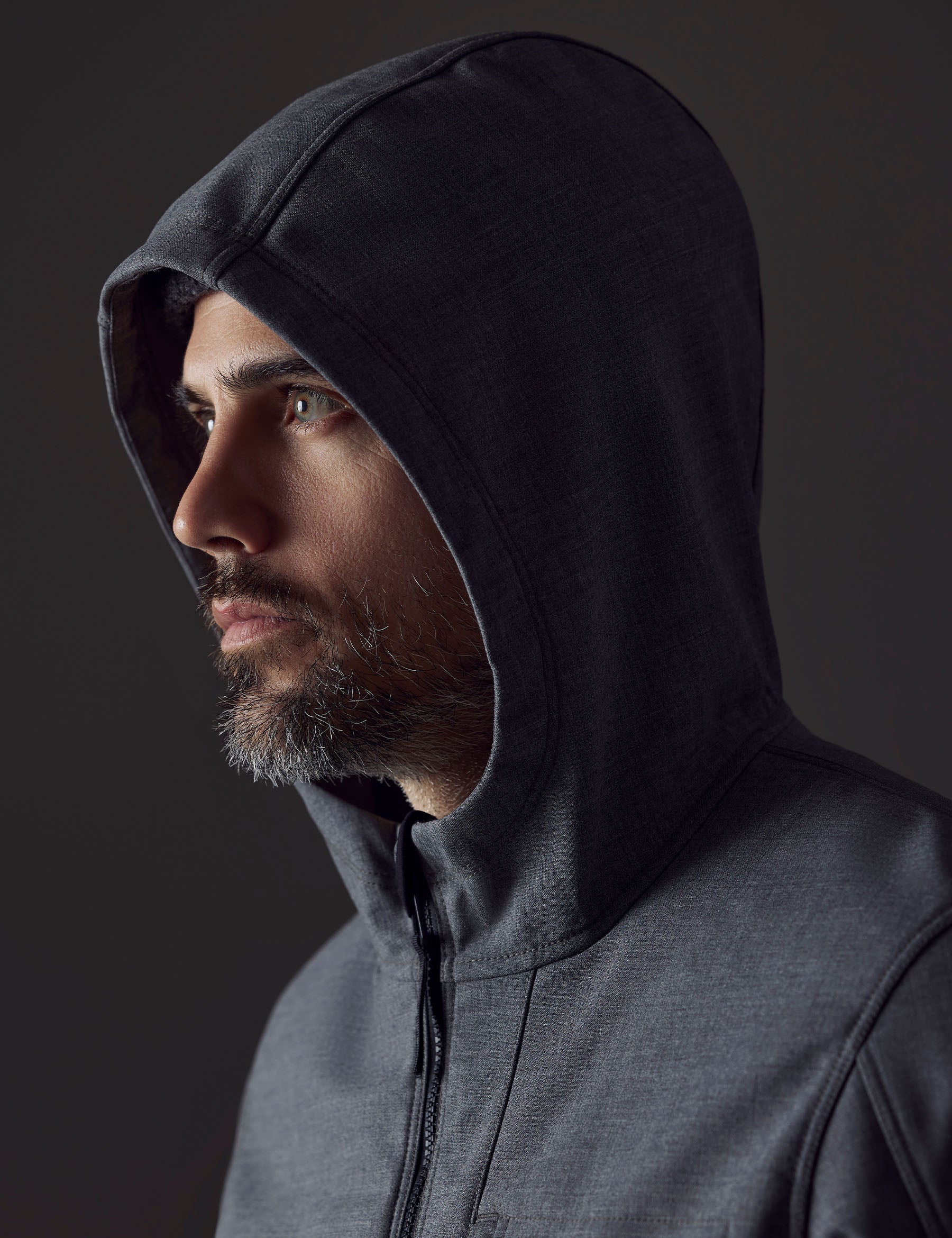 Closeup detailed view of man wearing the three-piece hood on the Stanton Technical Jacket in Light Heather Grey from AETHER Apparel.