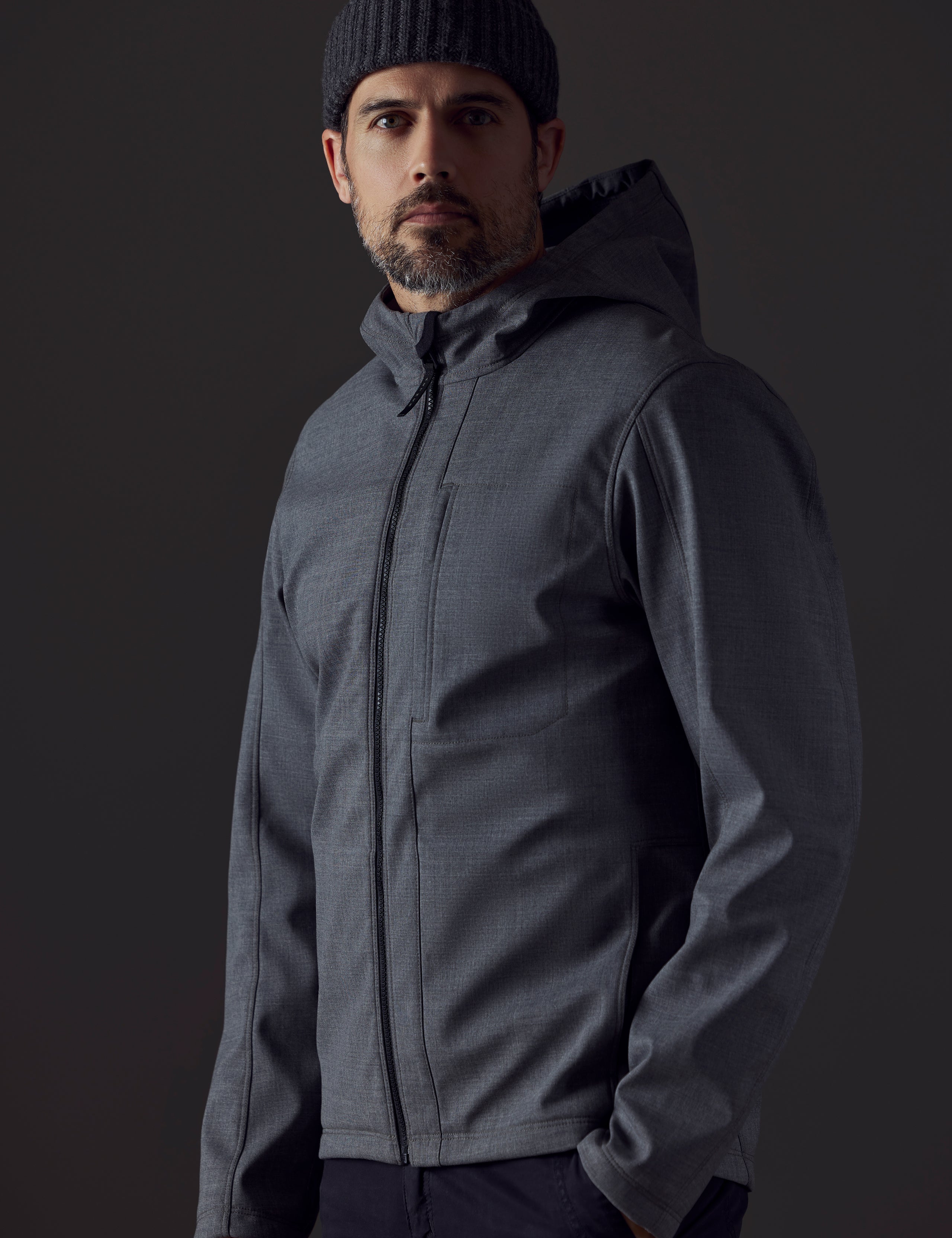 Front 3/4 body view of man wearing Stanton Technical Jacket in Light Heather Grey from AETHER Apparel.