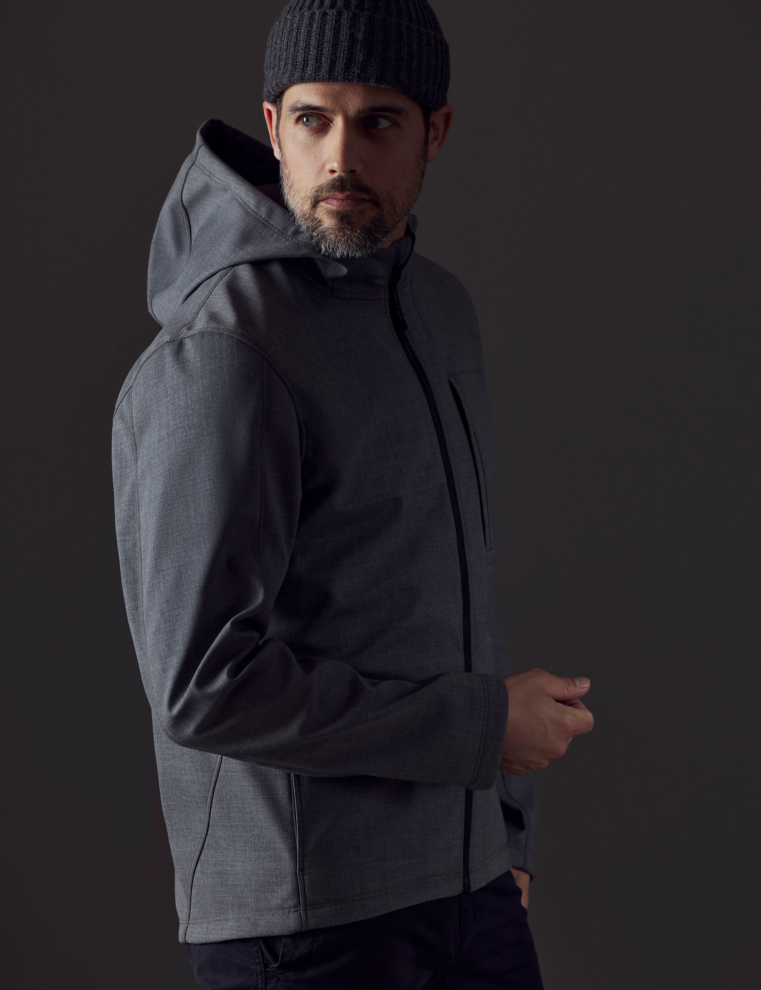 Side profile body view of man wearing Stanton Technical Jacket in Light Heather Grey from AETHER Apparel.