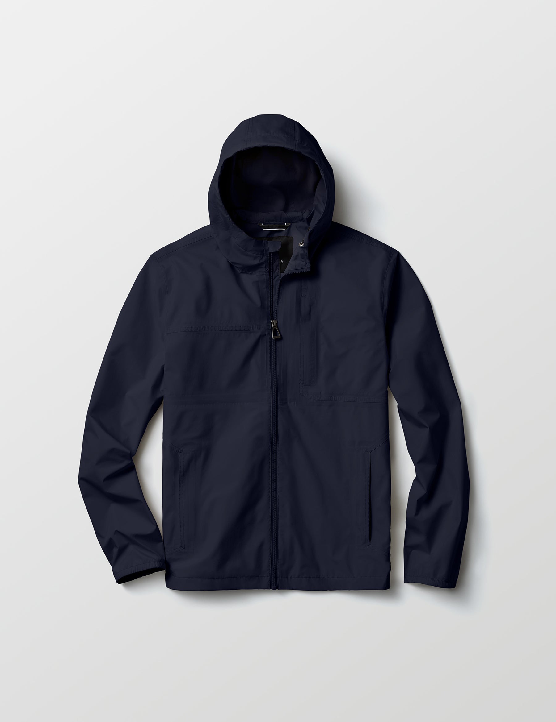 Flat lay view of Storm All-Weather Jacket in Total Eclipse dark blue from AETHER Apparel.