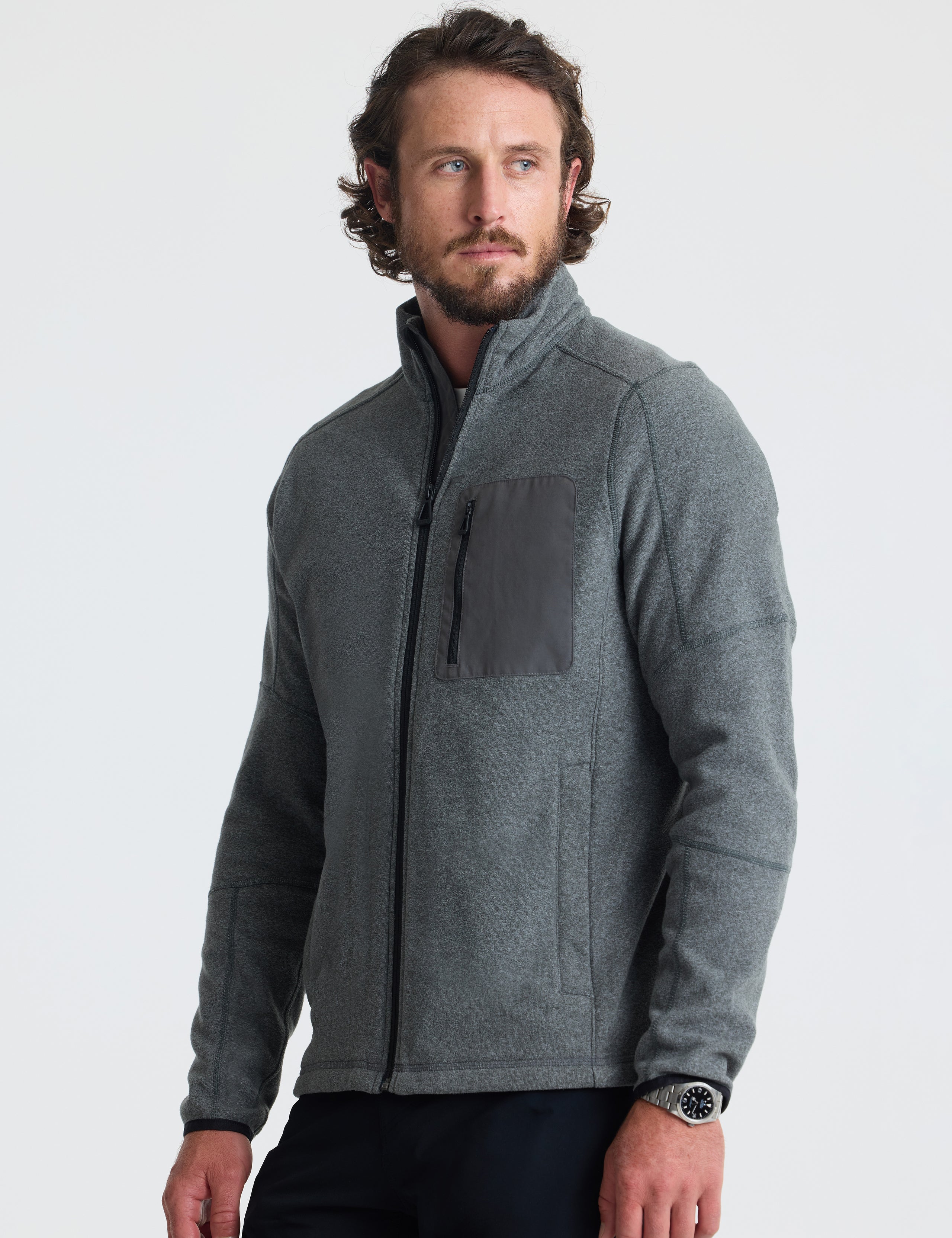 Angled view of man wearing Sutherlin Full-Zip in Charcoal Grey from AETHER Apparel.