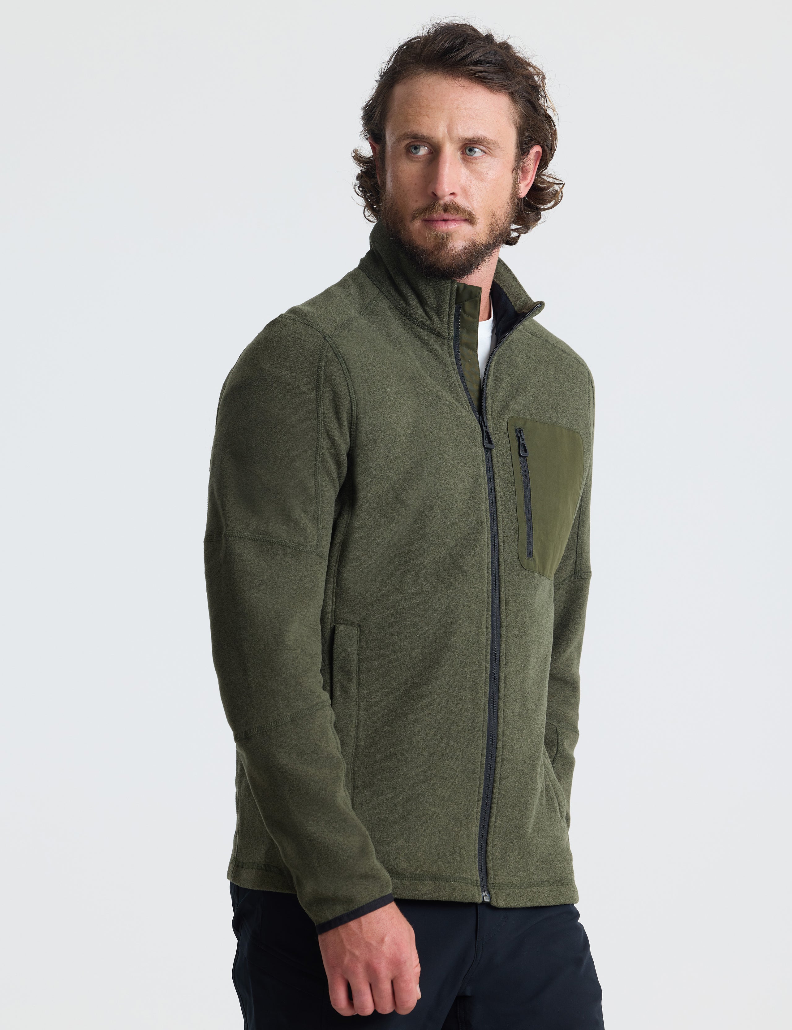 Angled view of man wearing Sutherlin Full-Zip in Forest Green from AETHER Apparel.