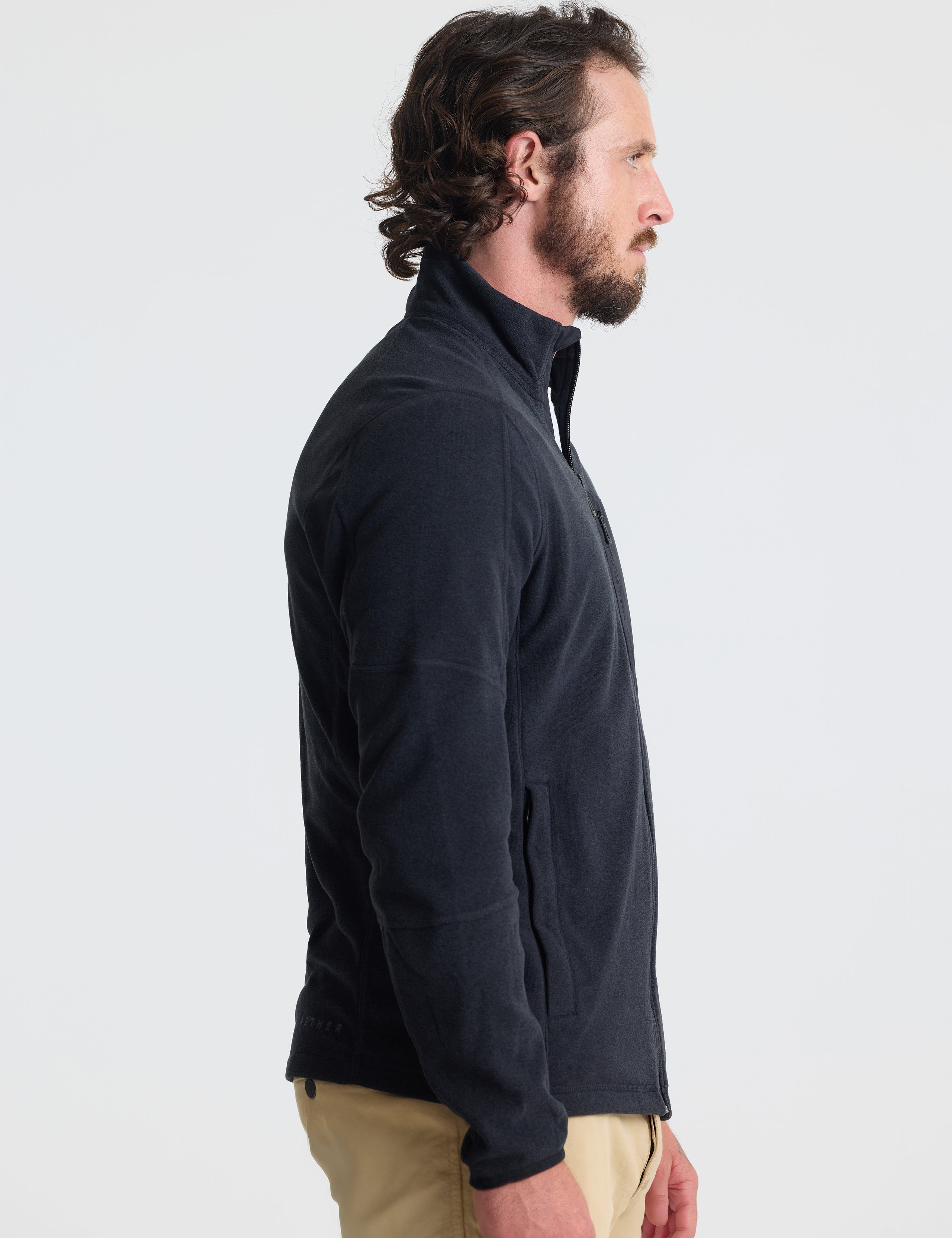 Right profile view of man wearing Sutherlin Full-Zip in Onyx Black from AETHER Apparel.