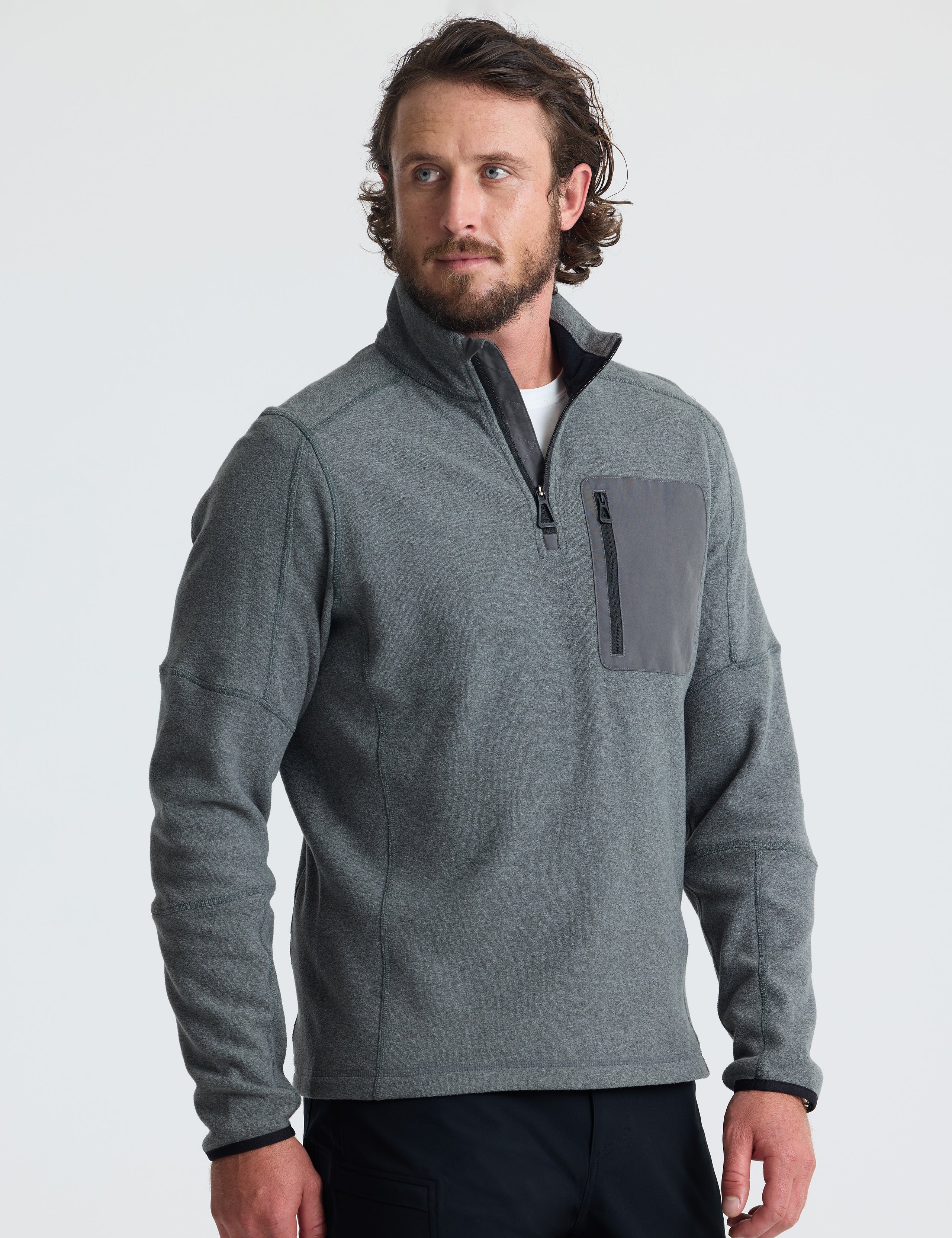 Angled view of man wearing Sutherlin Half-Zip in Charcoal Heather from AETHER Apparel.