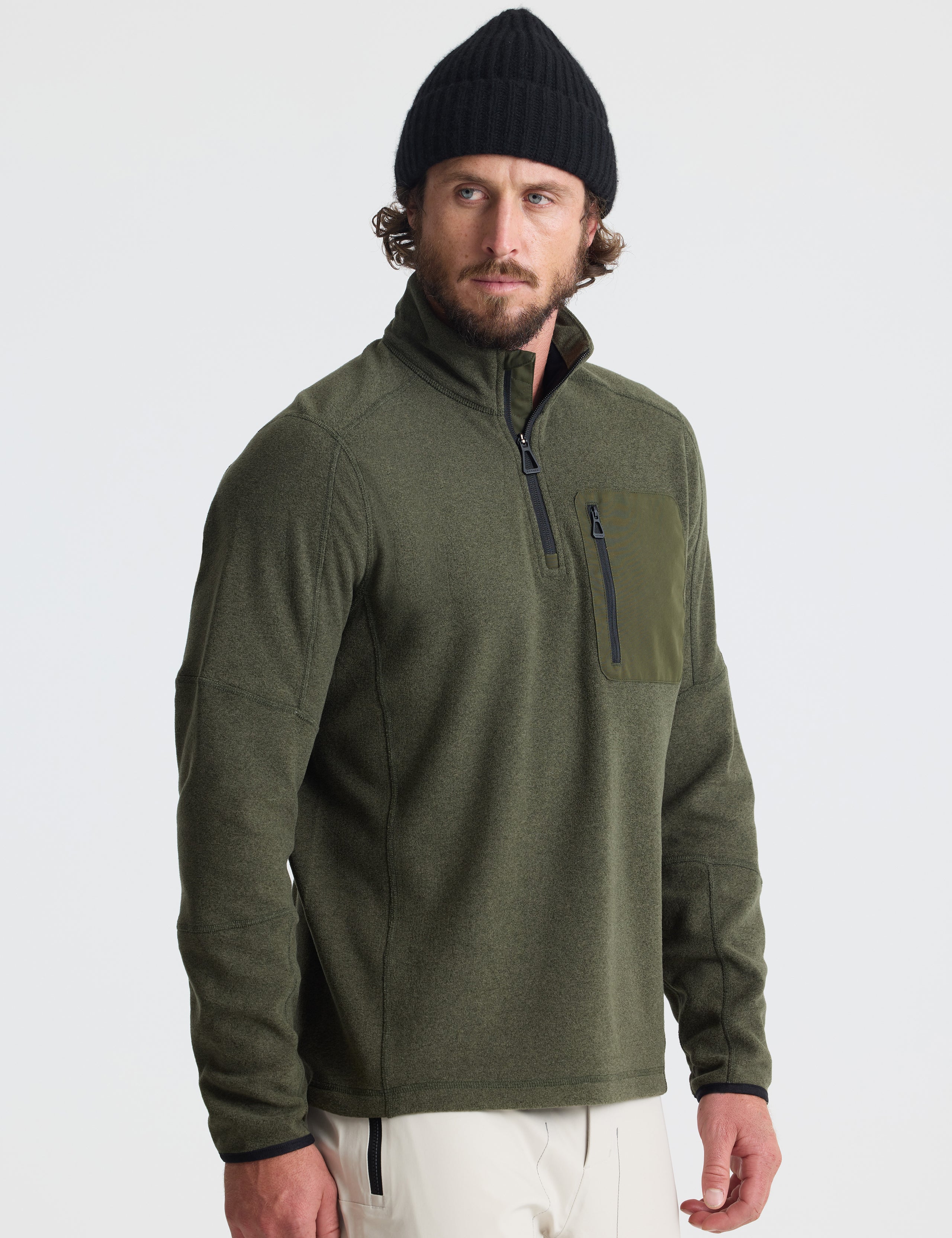 Angled view of man wearing Sutherlin Half-Zip in Forest Green from AETHER Apparel.