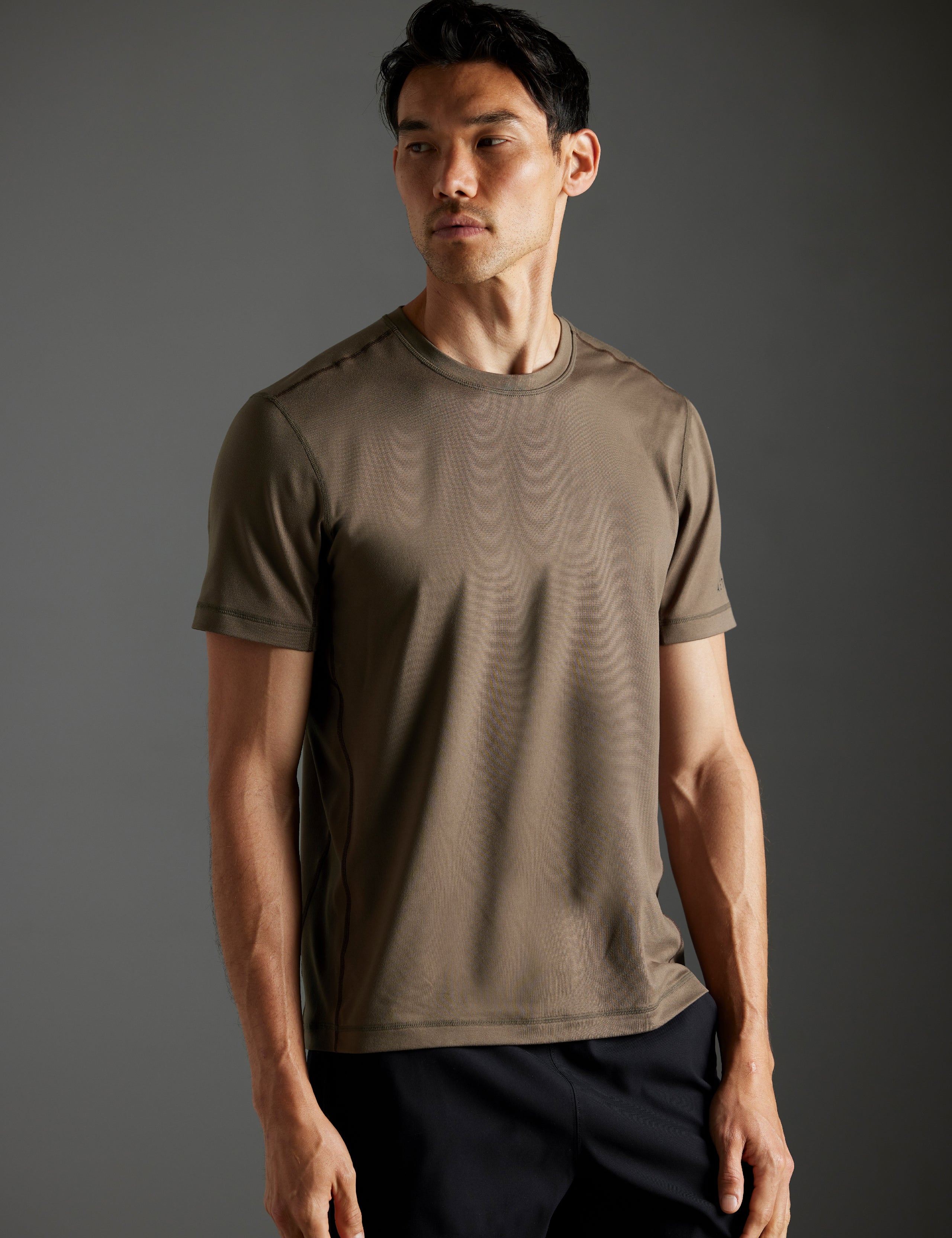Front body view of man wearing Trek Articulated Tee in Cadet green from AETHER Apparel.