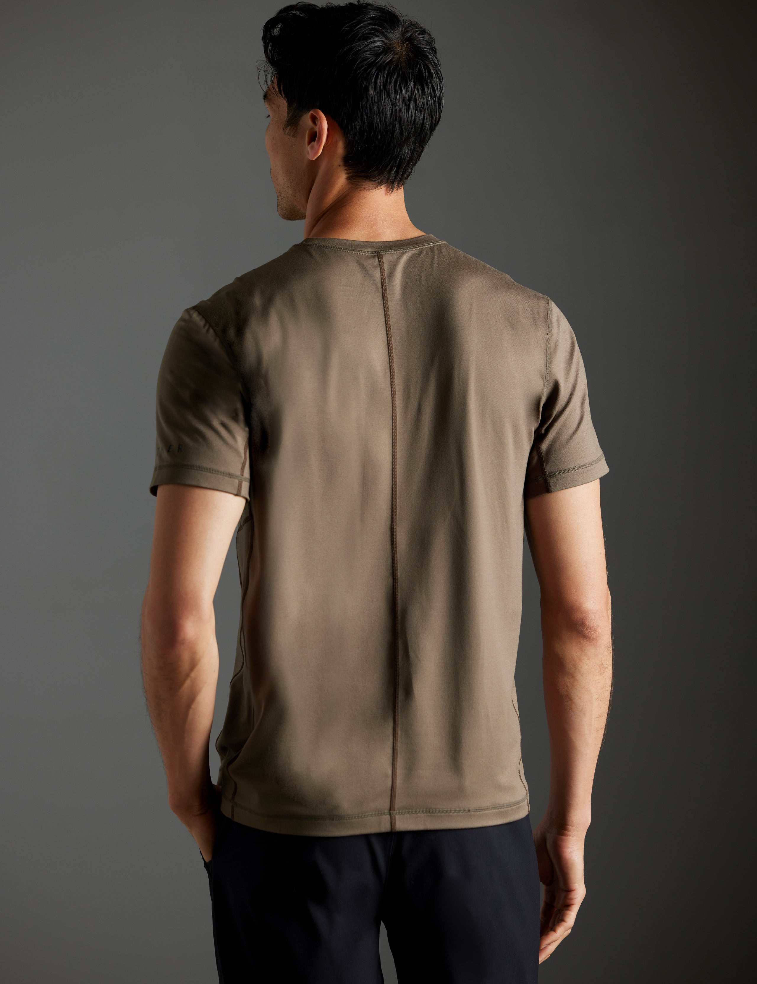 Rear body view of man wearing Trek Articulated Tee in Cadet green from AETHER Apparel.