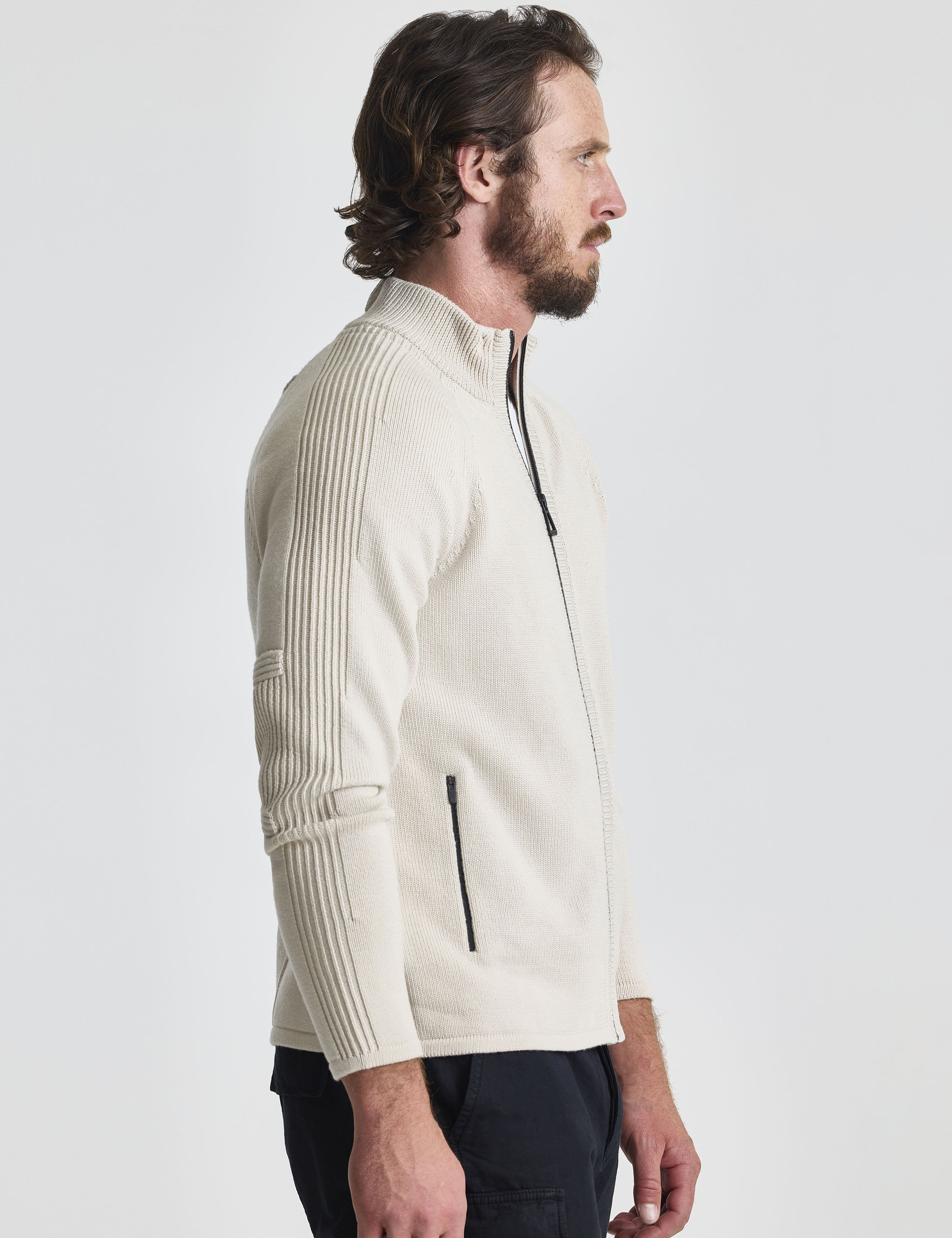 Right profile view of man wearing Riley Full-Zip Sweater in Bone white from AETHER Apparel.