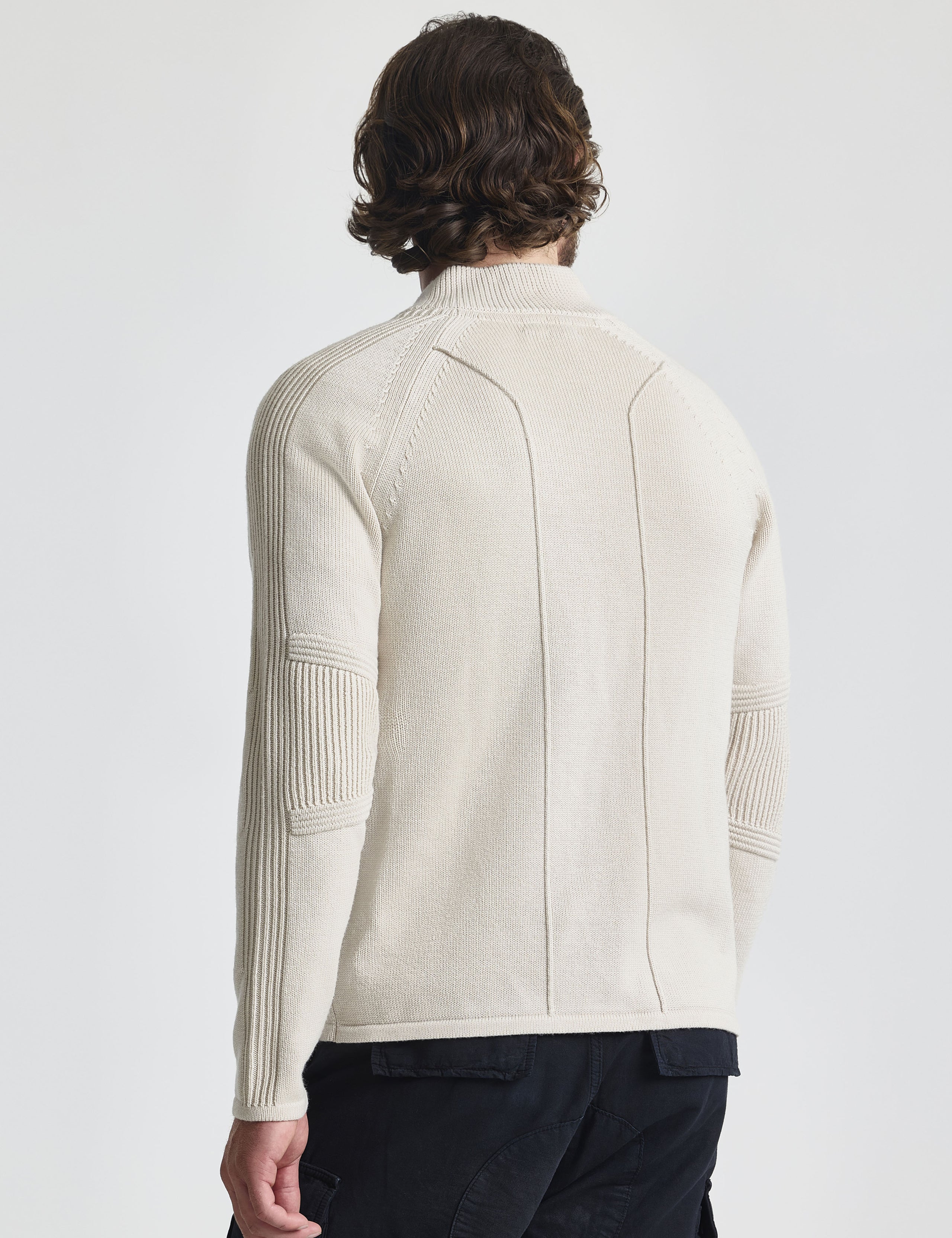 Rear view of man wearing Riley Full-Zip Sweater in Bone white from AETHER Apparel.