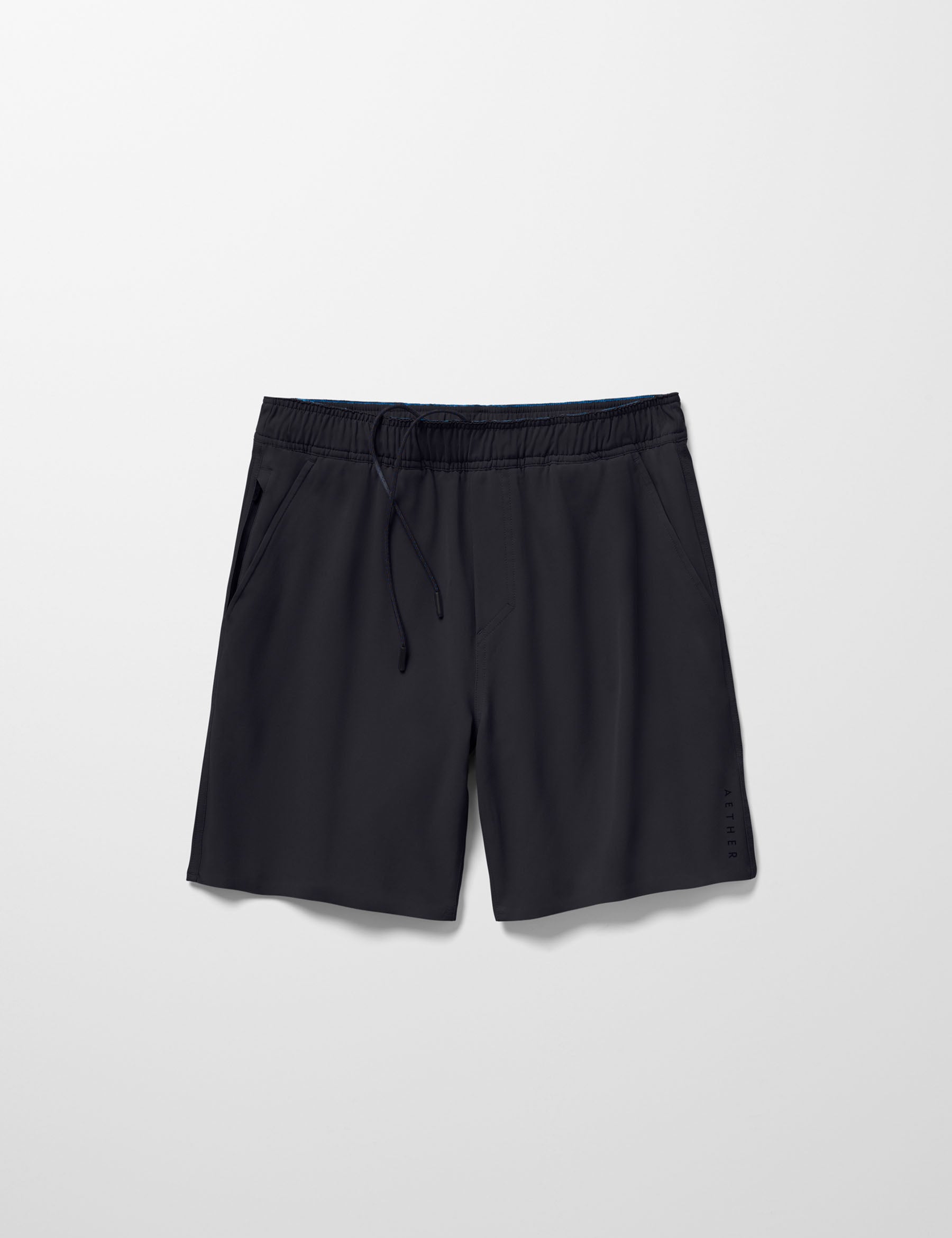 Flay lay image of Rogue Hybrid Short in Onyx Black from AETHER Apparel.